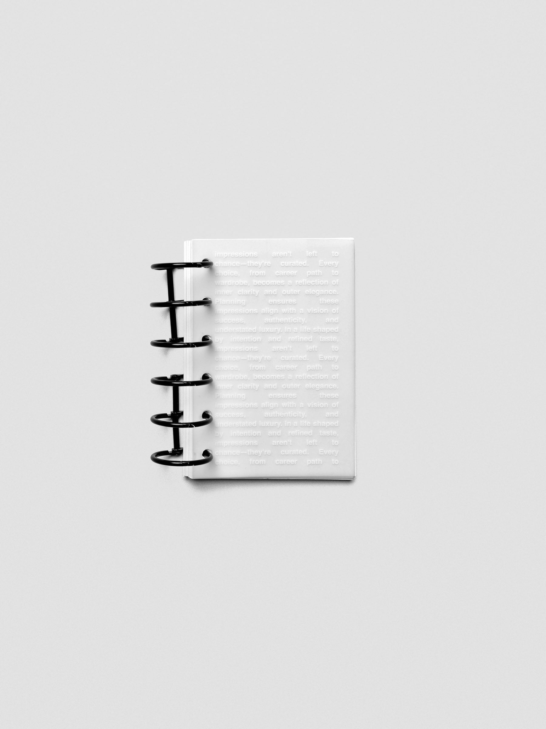 Pocket-size Impressions Dashboard shown in a planner with translucent layering.
