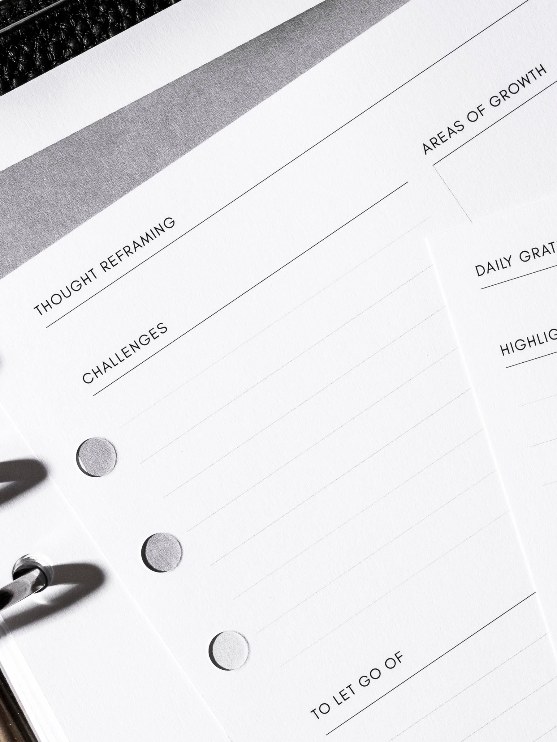 Closeup of inserts inside black leather agenda.