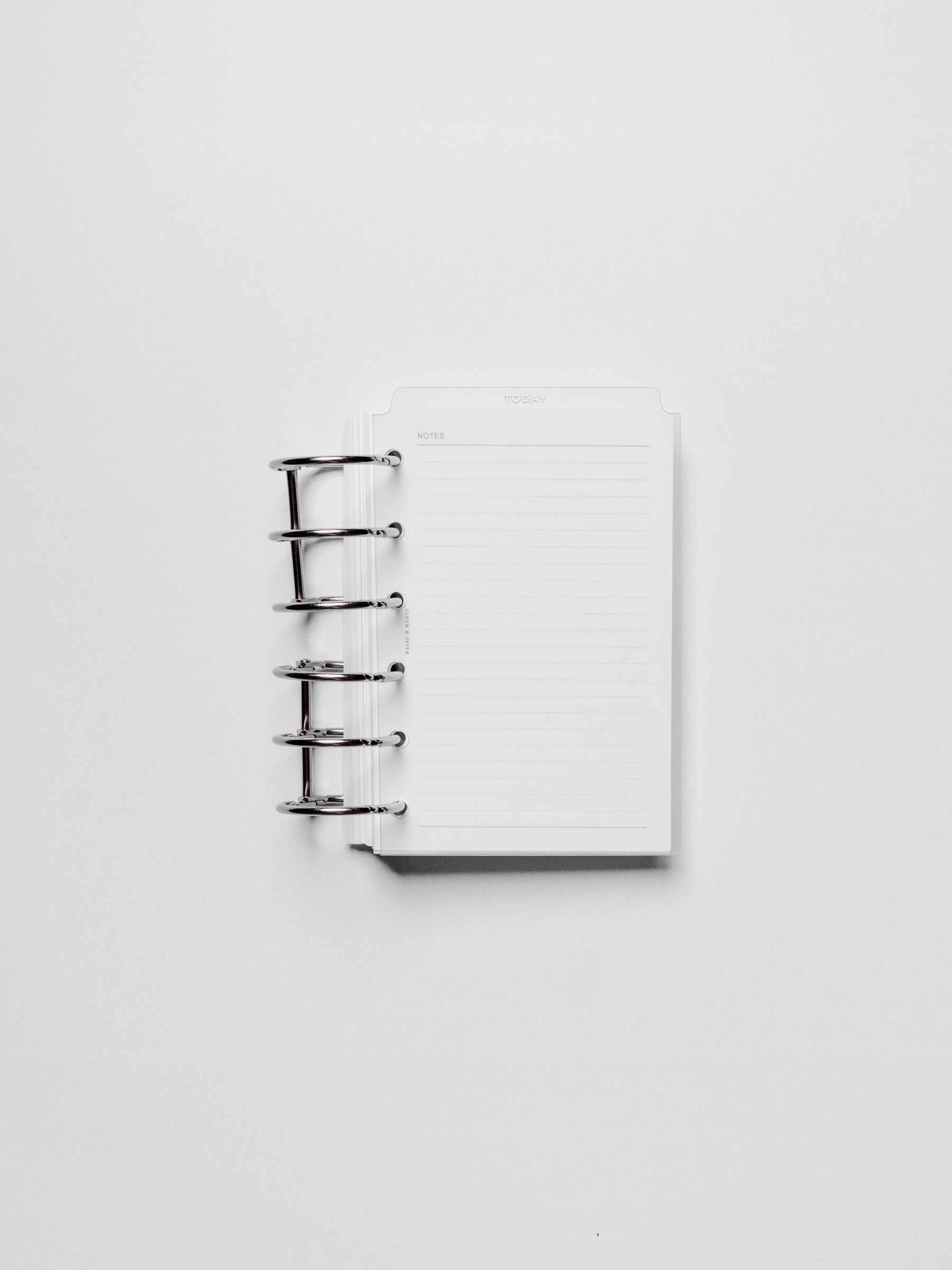 White foil divider displayed in a metal ring.