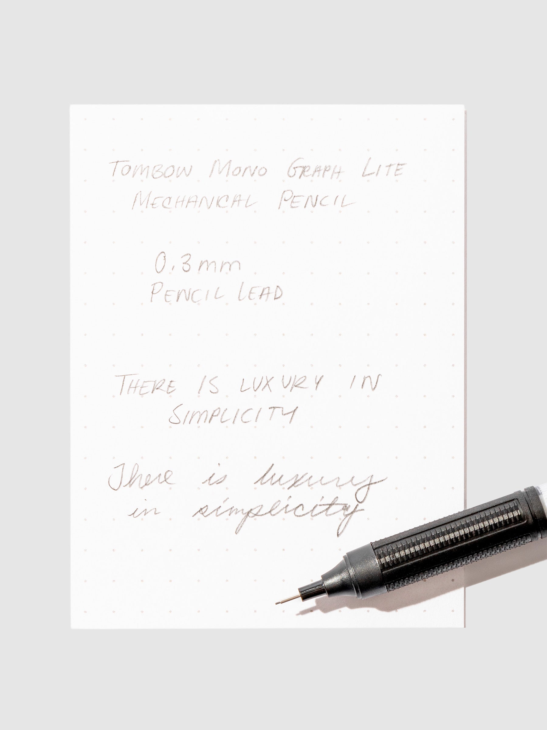 Writing sample with pencil displayed on a background.eutral