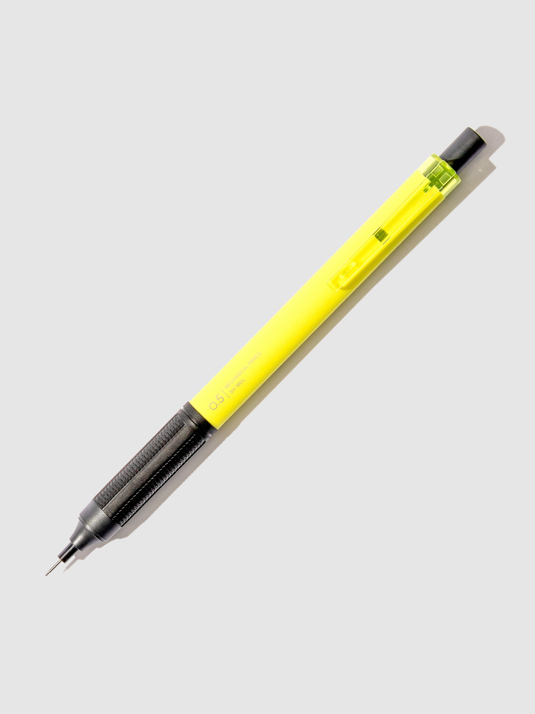 Neon yellow pencil displayed on a neutral background.