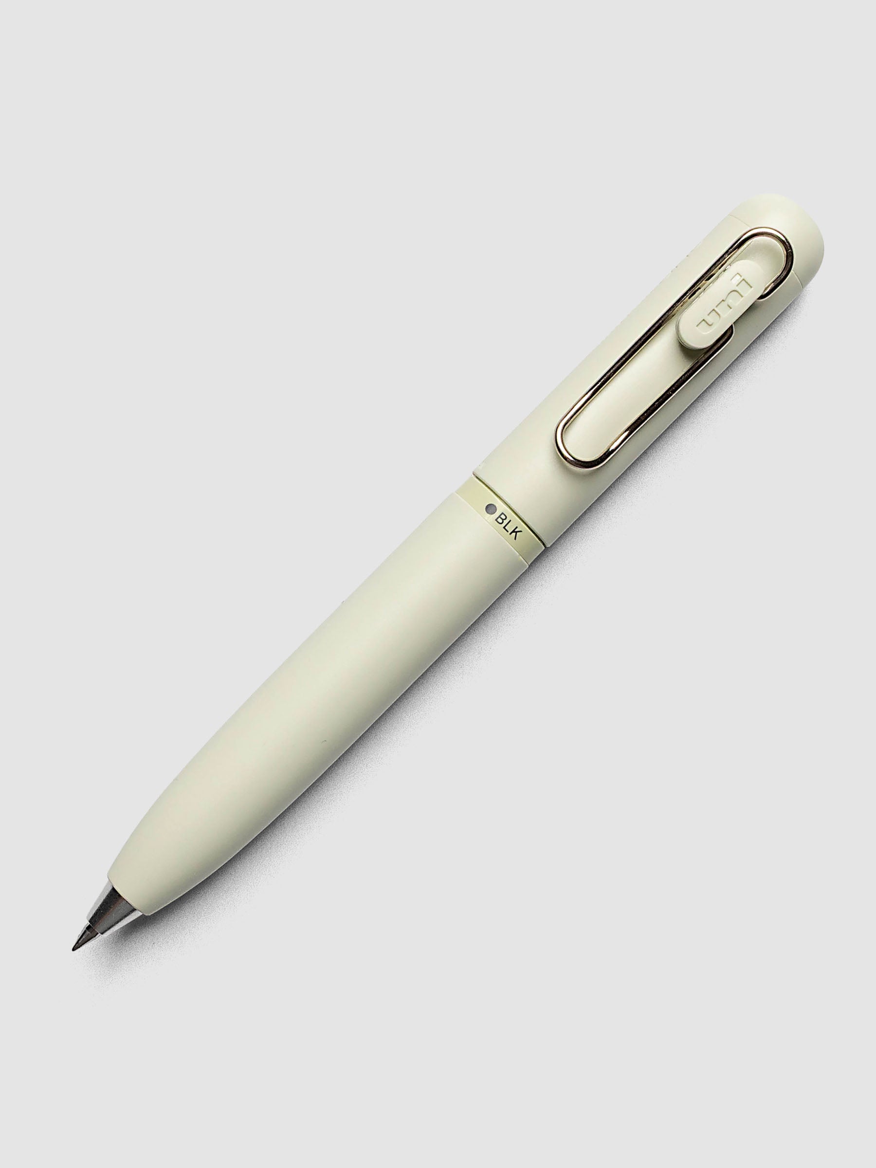 Uni-ball One 3-Color Ballpoint Pen in pale sage green close up of clip and BLK color indicator