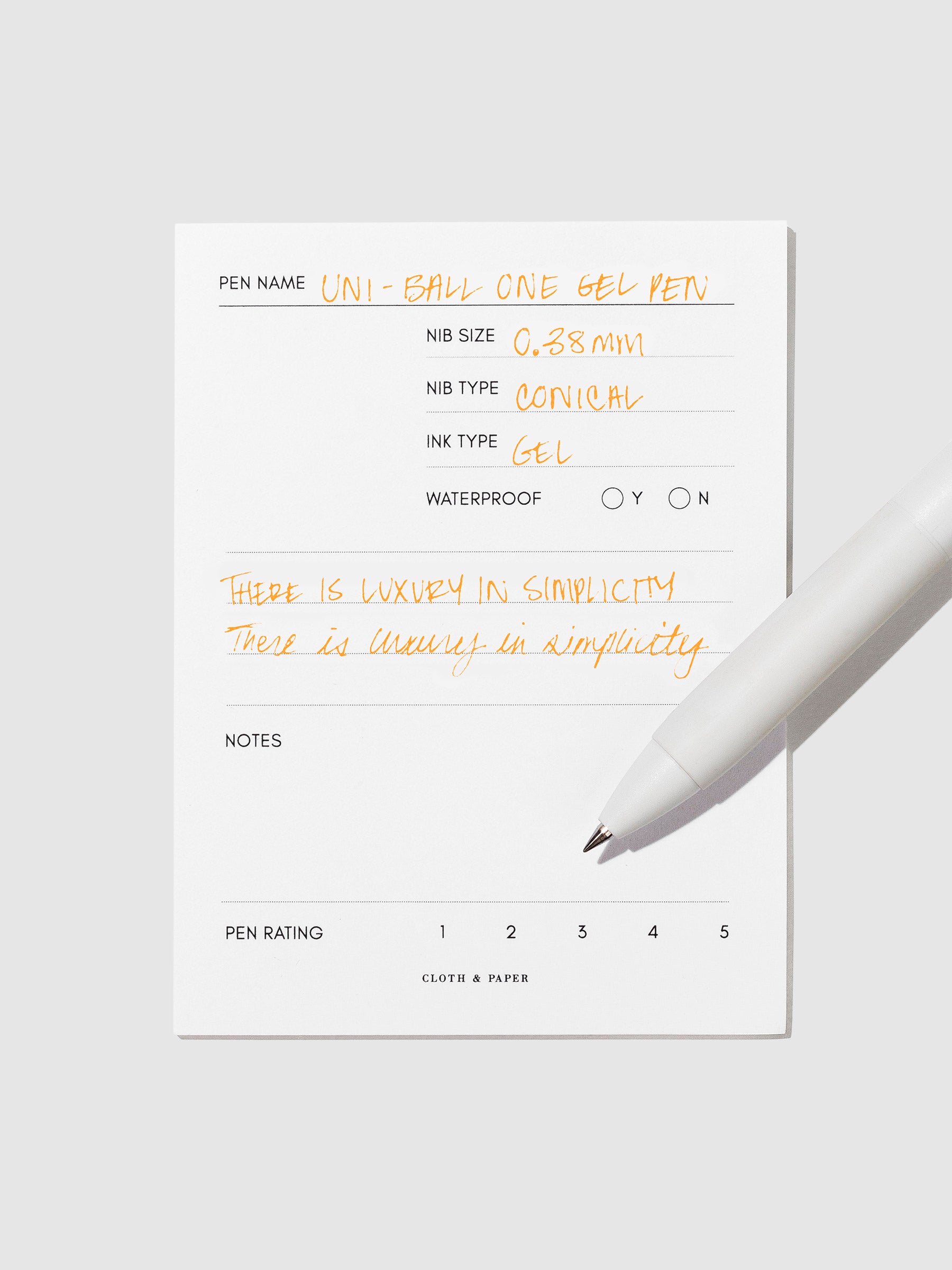 Pen tilted slightly to the right on a neutral background. Color pictured is Orange Cocktail.