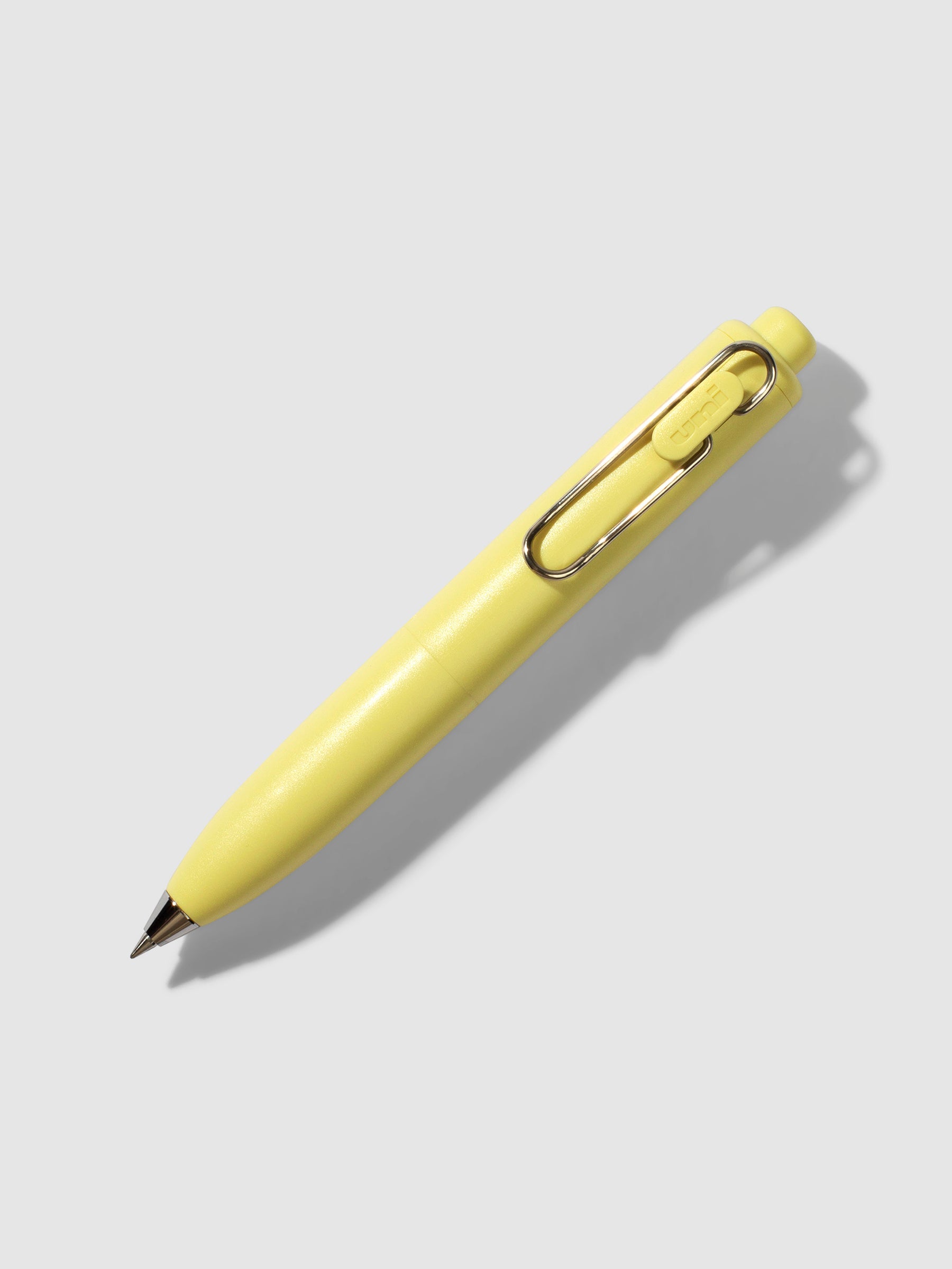 Uni-Ball One P Gel Pen, Cloth and Paper. Pen turned to the right on a neutral background. Color pictured is Banana.