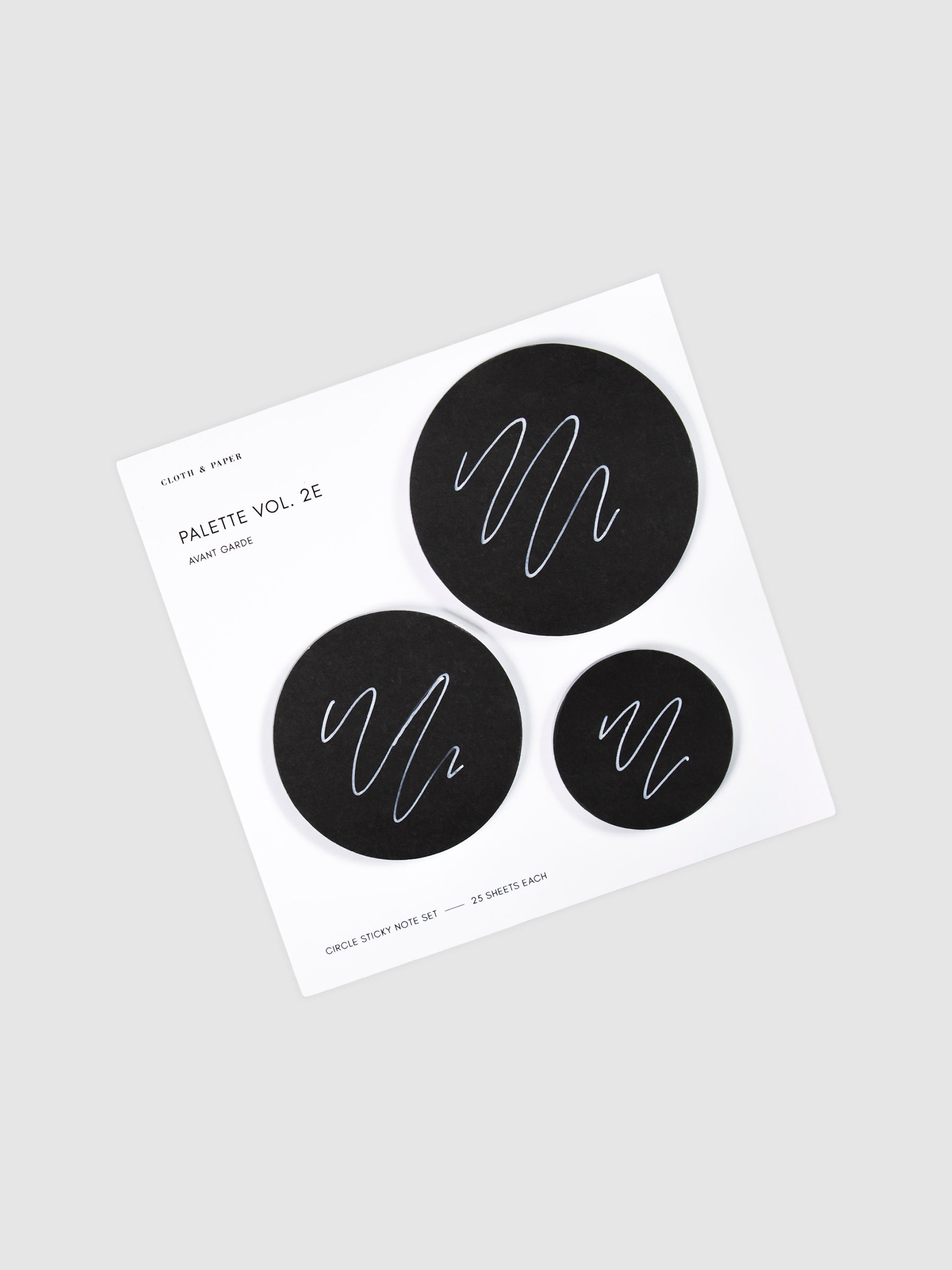 Uni Posca Paint Marker, Ultra Fine Point, White, Cloth and Paper. Marker writing sample displayed on Circle Sticky Note Set in Avant Garde or black paper.