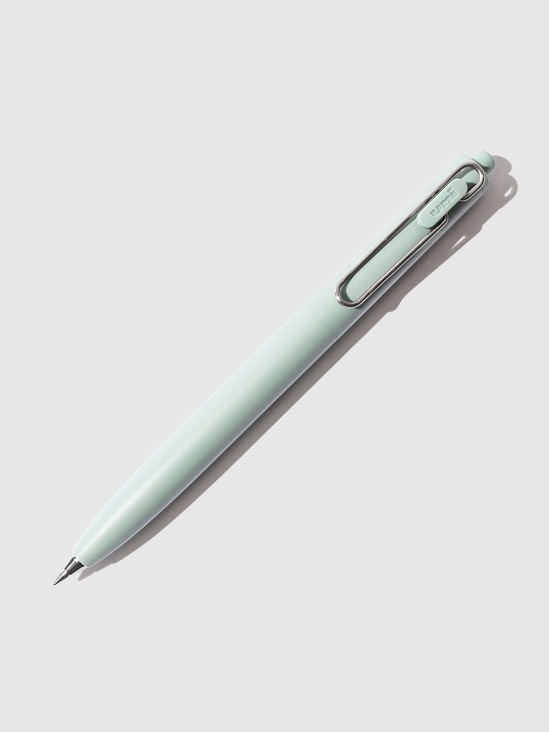 Green pen turned to the right against a neutral background.