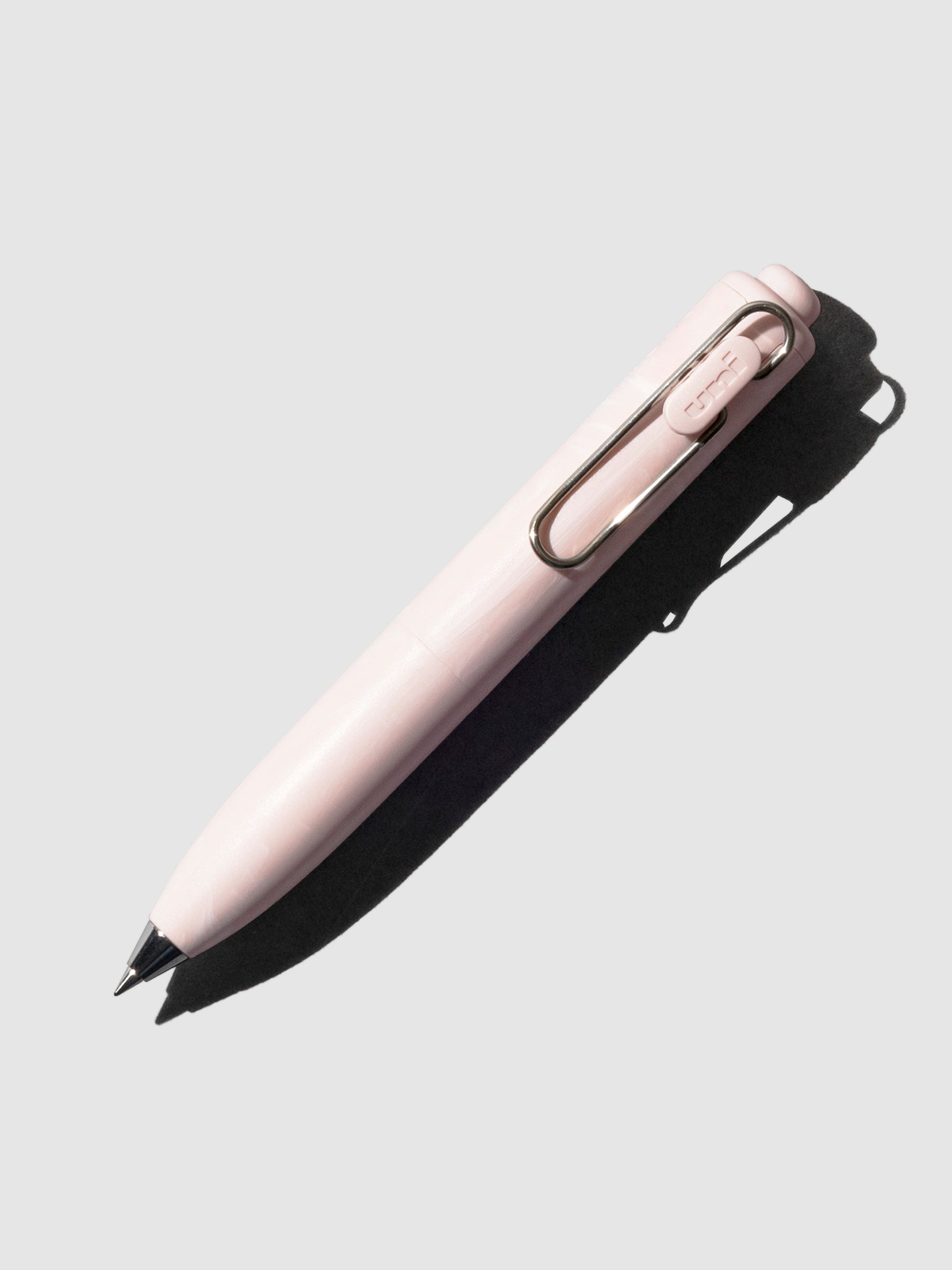 Uni-Ball One P Gel Pen, Cloth and Paper. Pen turned to the right on a neutral background. Color pictured is Peony.