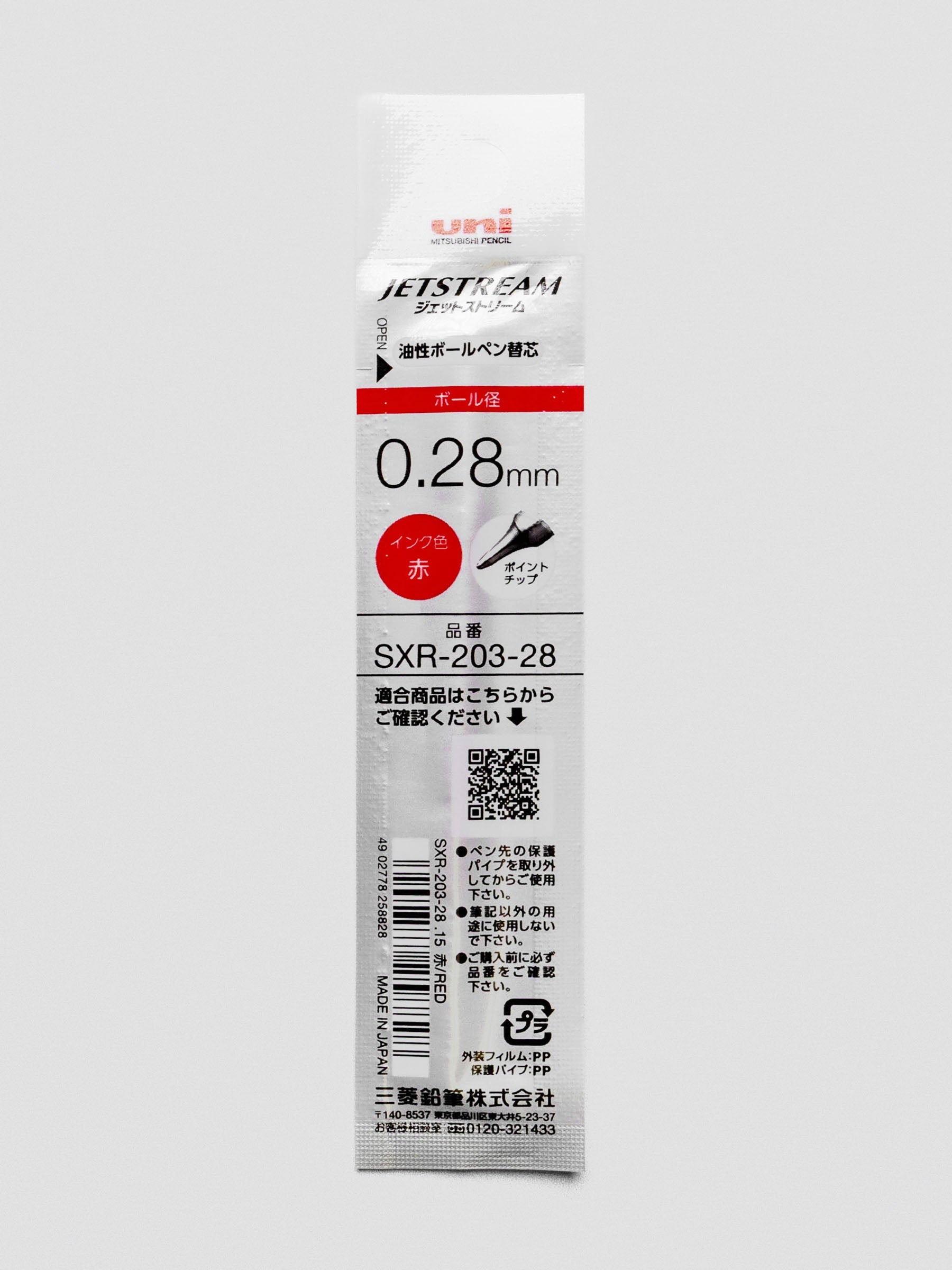 Back view of a pen refill with red ink shown in packaging.