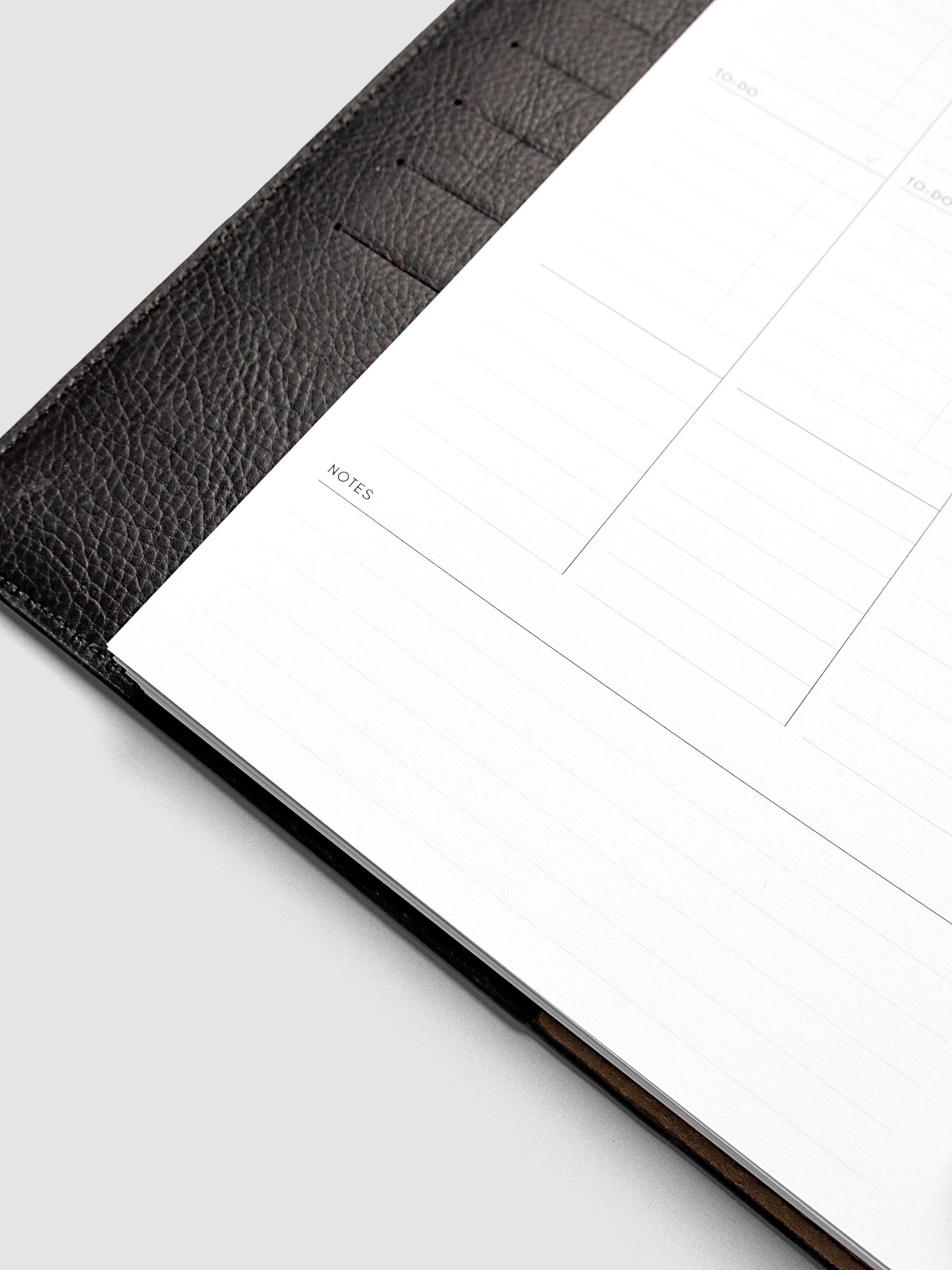 2027 Dated Weekly Task Planner Inserts, Monday Start, Half Letter 8-Disc Punch, close-up of the bottom of the left page showing open daily notes space and the weekly notes section along the bottom of the spread