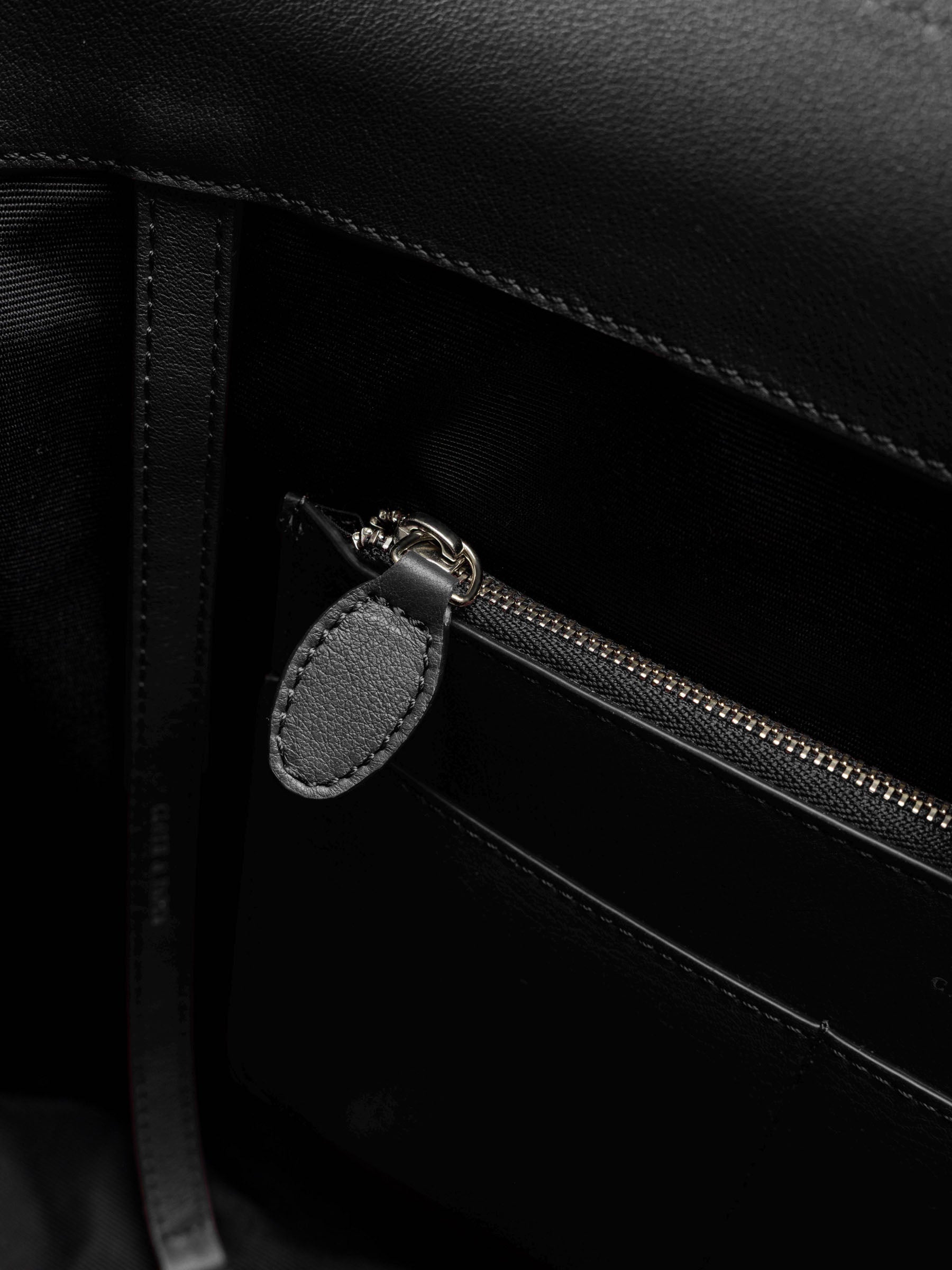Detail view of the zip closure inner  pocket on The Metro Tote in the color Padrillo.
