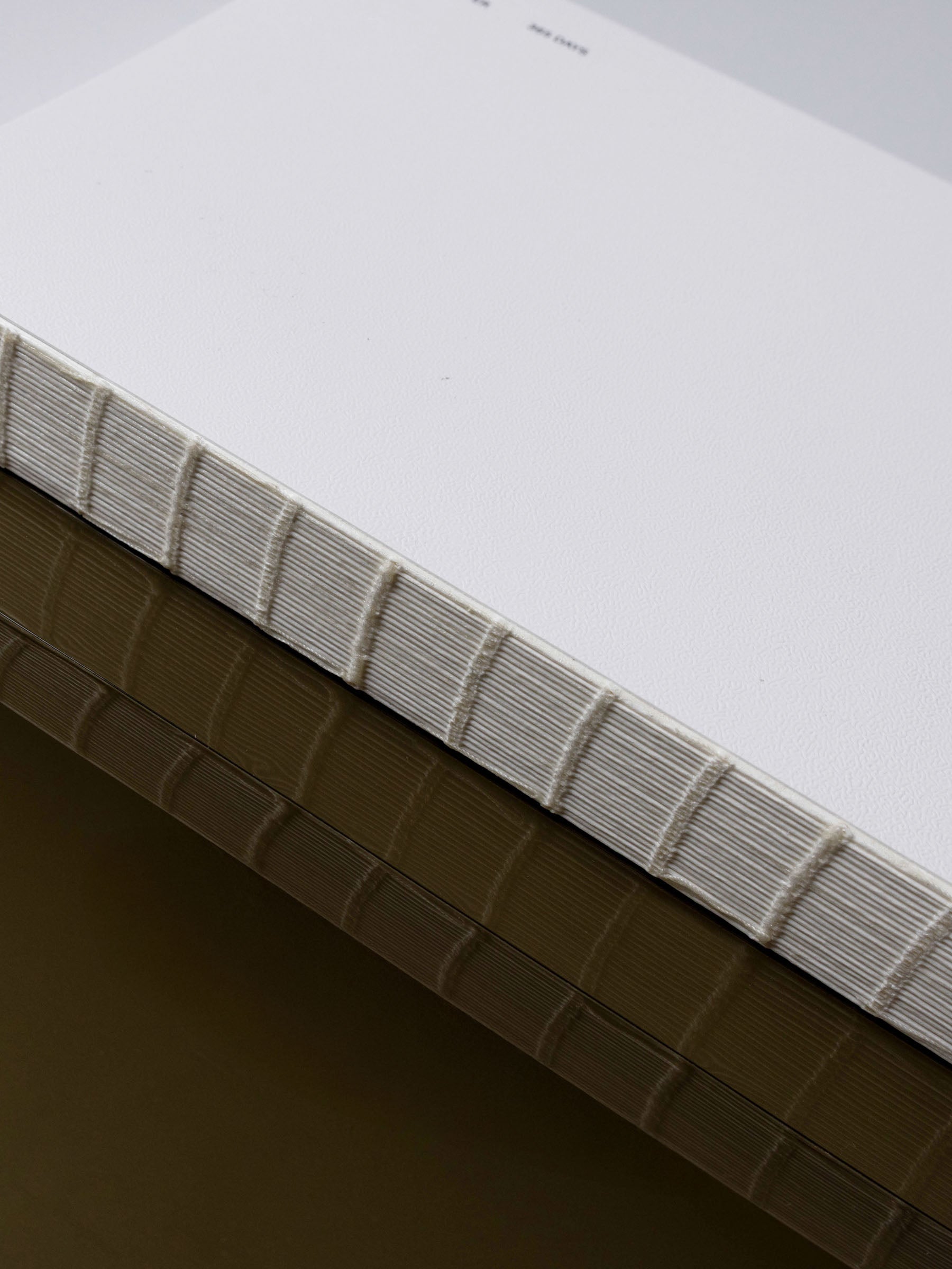 A5 notebook displayed on a neutral background, showing its exposed spine.