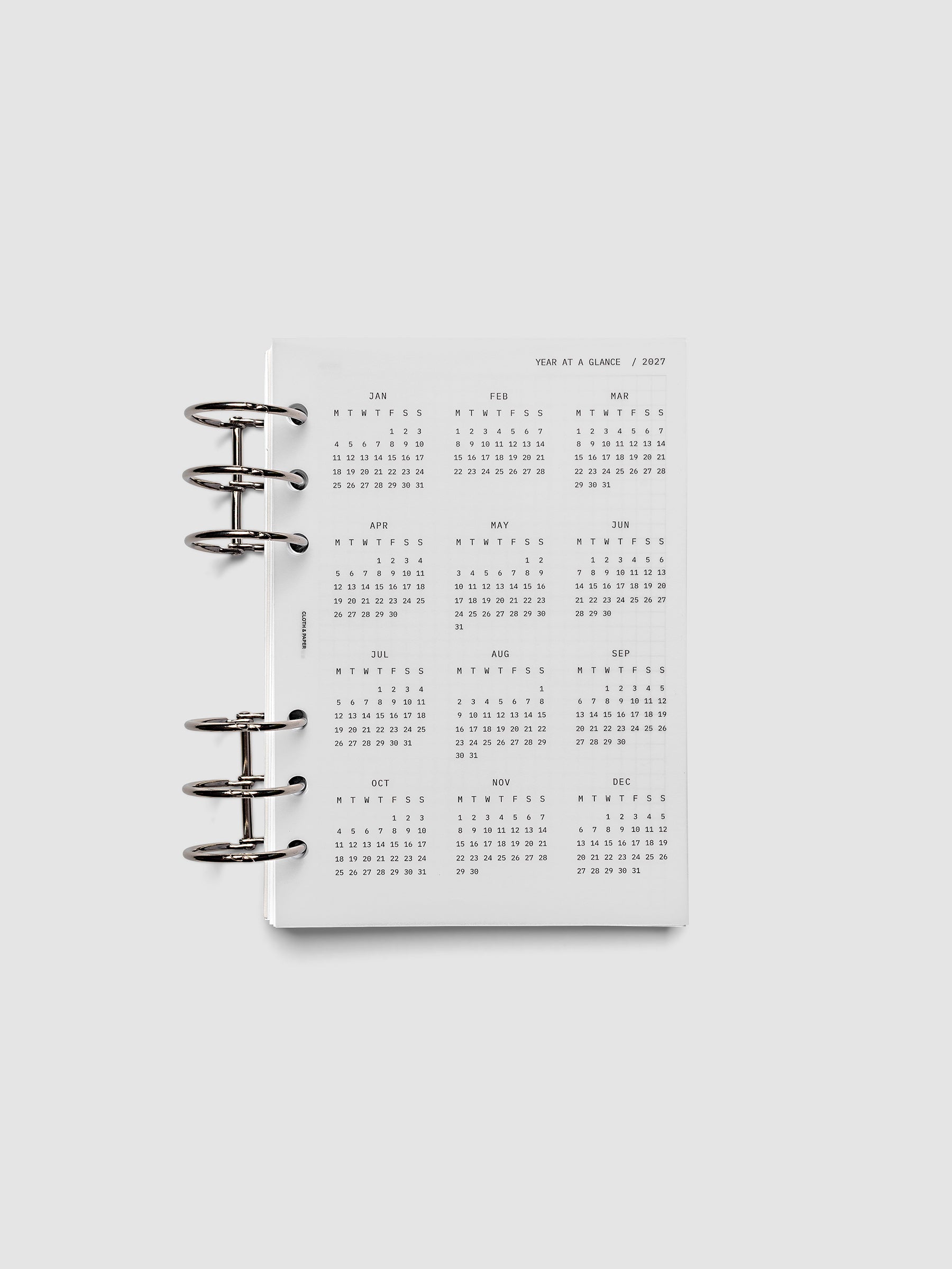 2027 Year At A Glance Dashboard Monday Start, Personal Wide 6-Ring Punch, translucent vellum year-at-a-glance calendar shown inside a planner