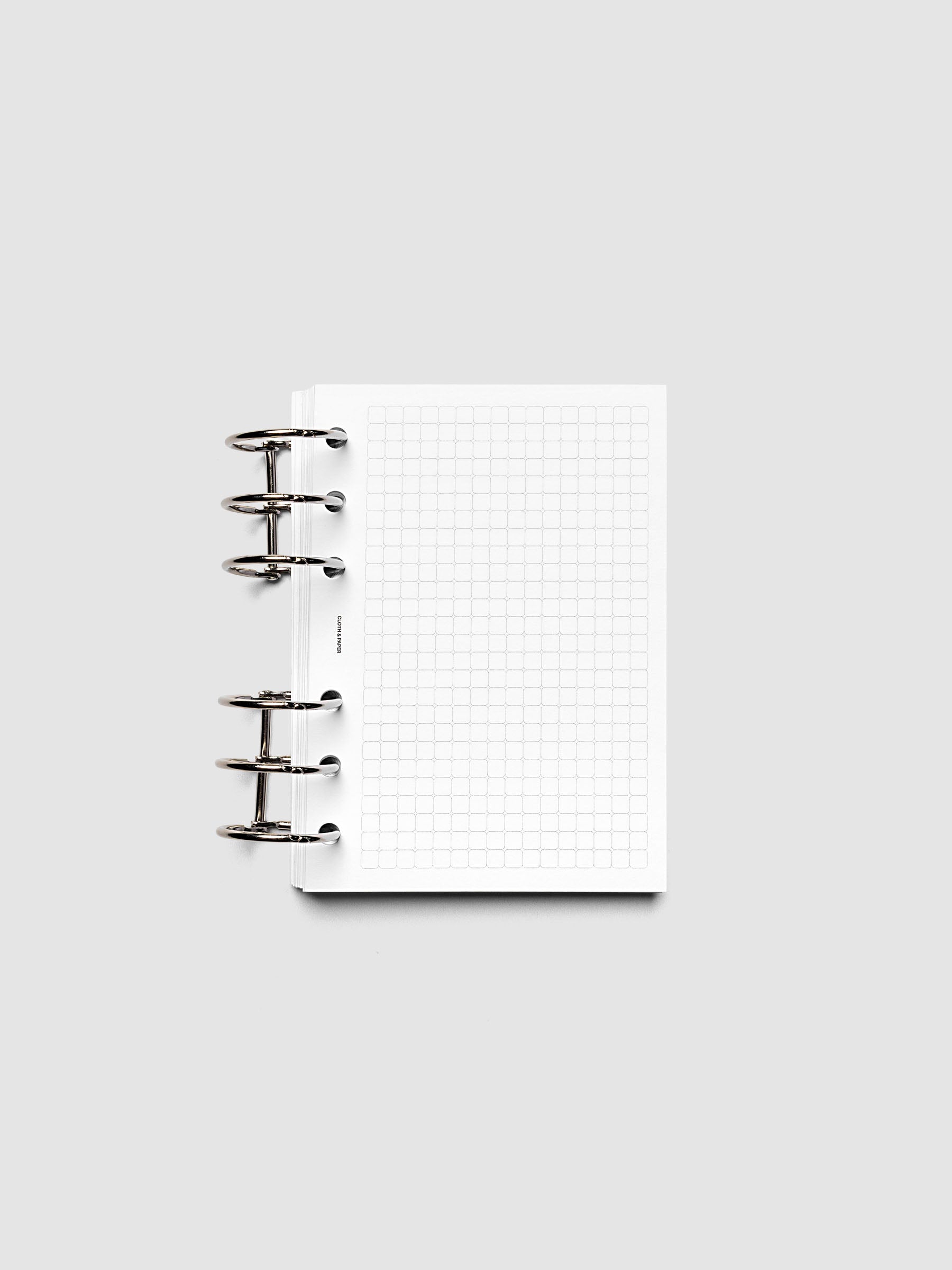 Rounded Graph Planner Insert A6 6-Ring Punch open to an unused grid page