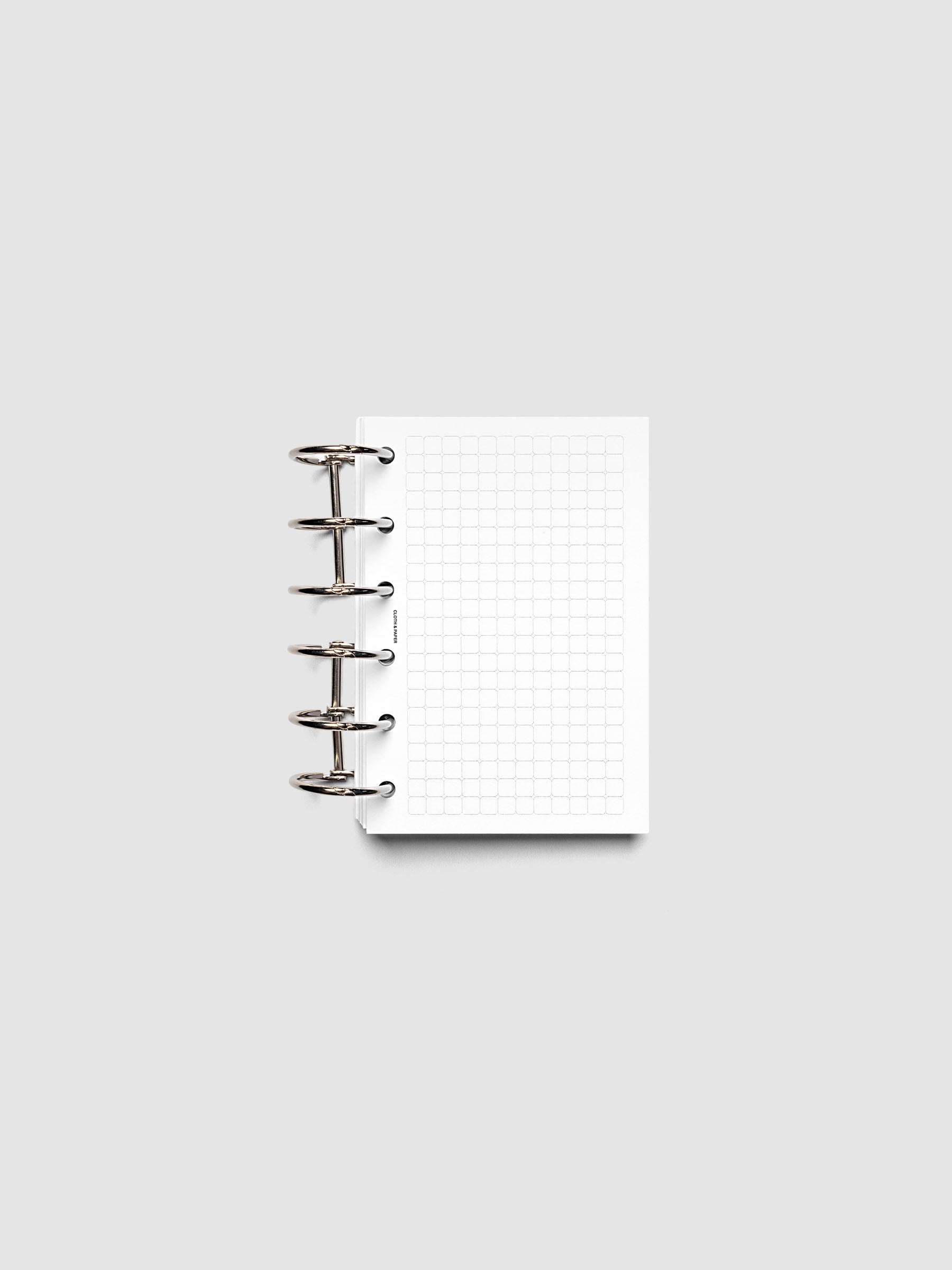 Rounded Graph Planner Insert Pocket 6-Ring Punch open to an unused grid page