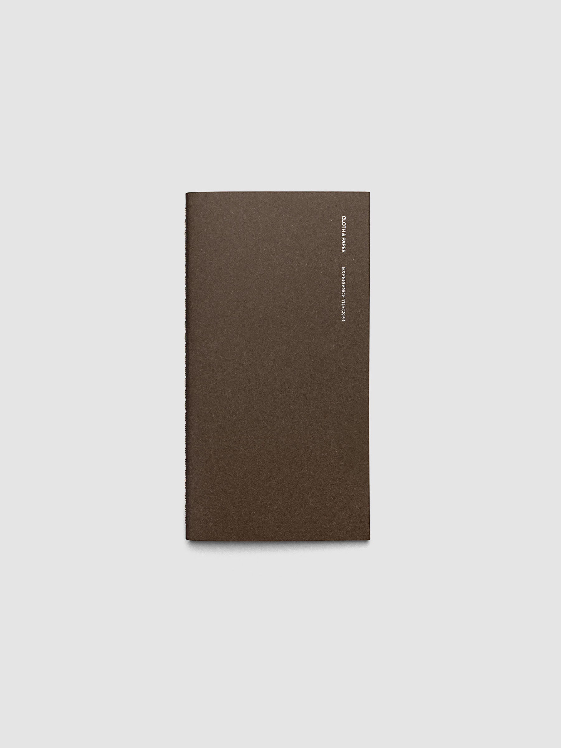 Overview image of the Experience Tracker Pocket Plus travel notebook in Walnut with gold foil cover text, displayed on a neutral background