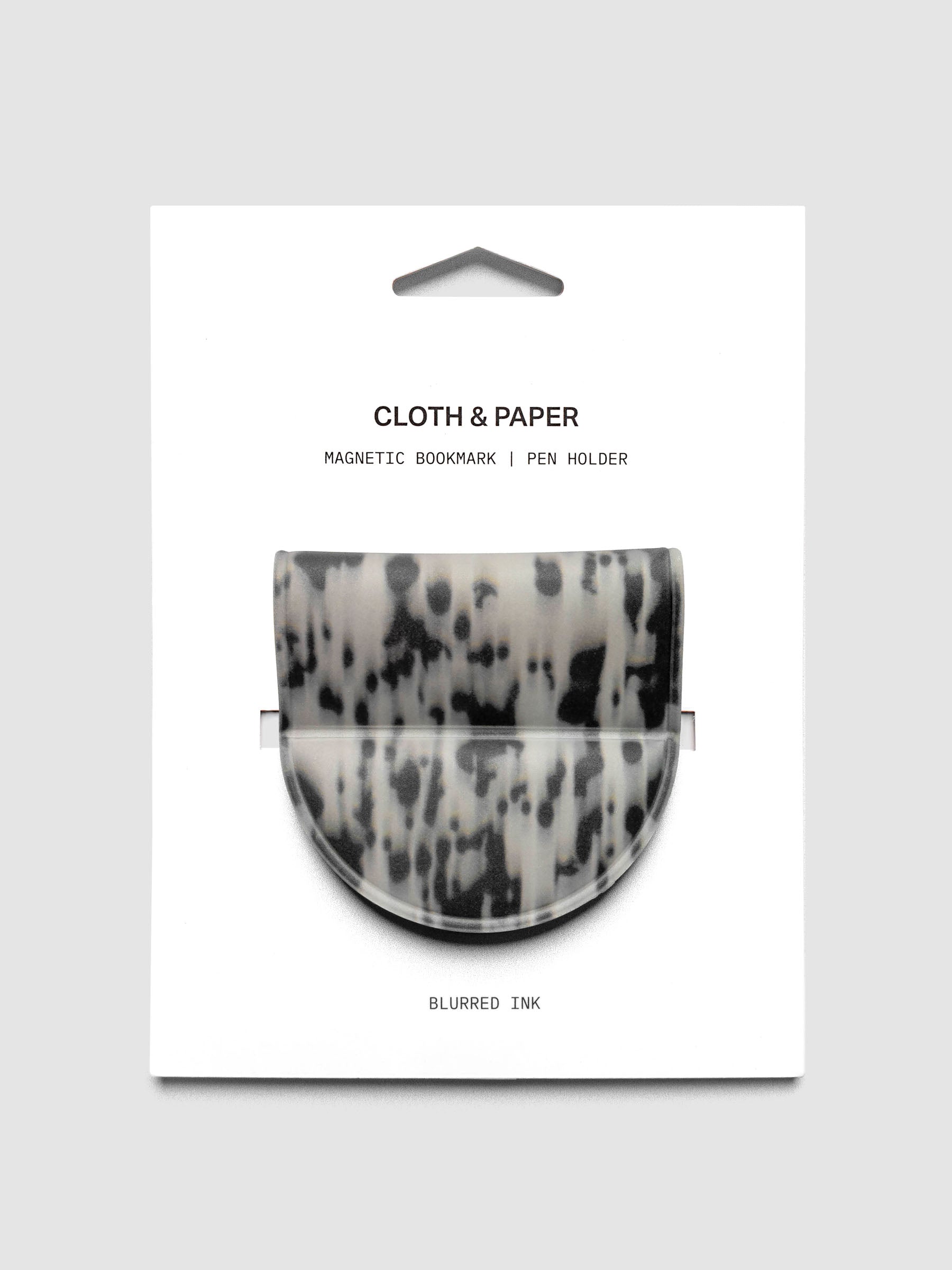Magnetic Bookmark | Pen Holder | Vinyl in Blurred Ink shown in retail packaging with a black and off-white speckled pattern