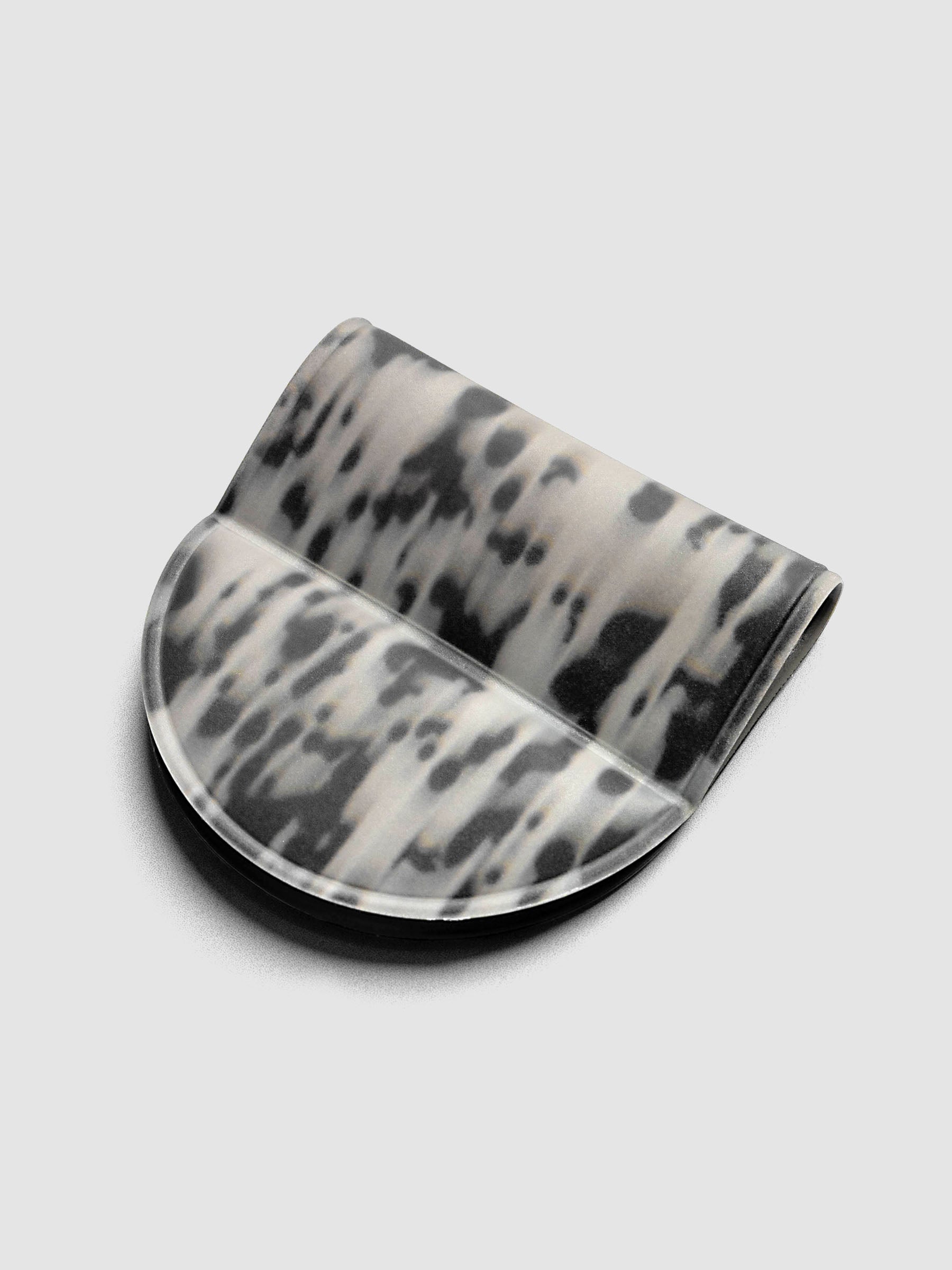 Magnetic Bookmark | Pen Holder | Vinyl in Blurred Ink, angled view showing black and off-white speckled pattern