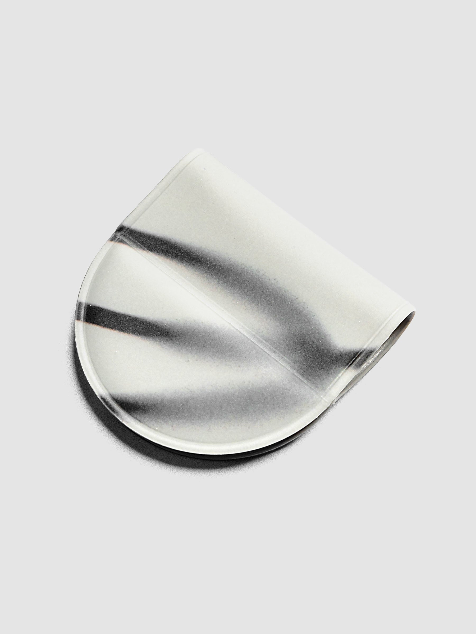 Magnetic Bookmark | Pen Holder | Vinyl in Blurred Line, angled view showing white base with sweeping dark gray brushstroke pattern