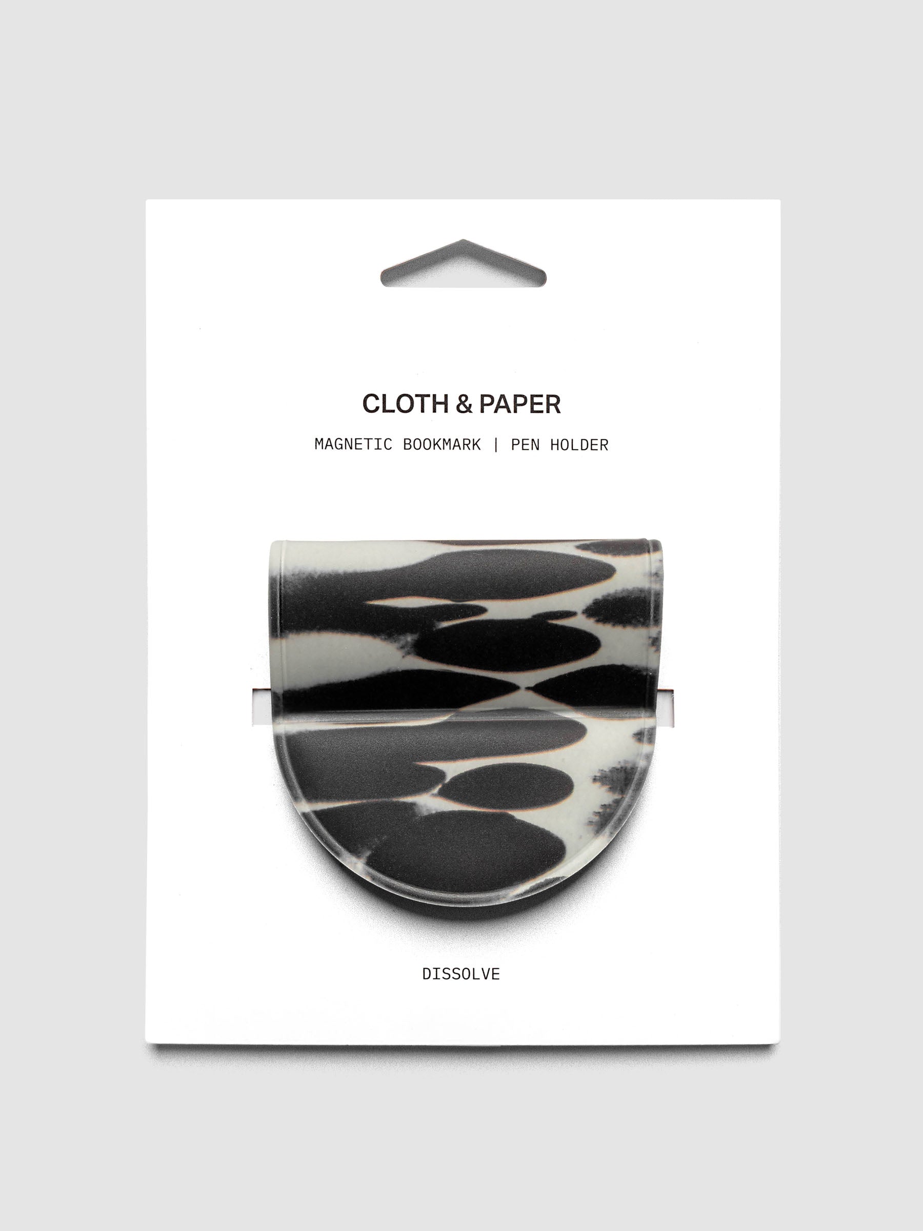 Magnetic Bookmark | Pen Holder | Vinyl in Dissolve shown in retail packaging with a high-contrast black and off-white oval pattern