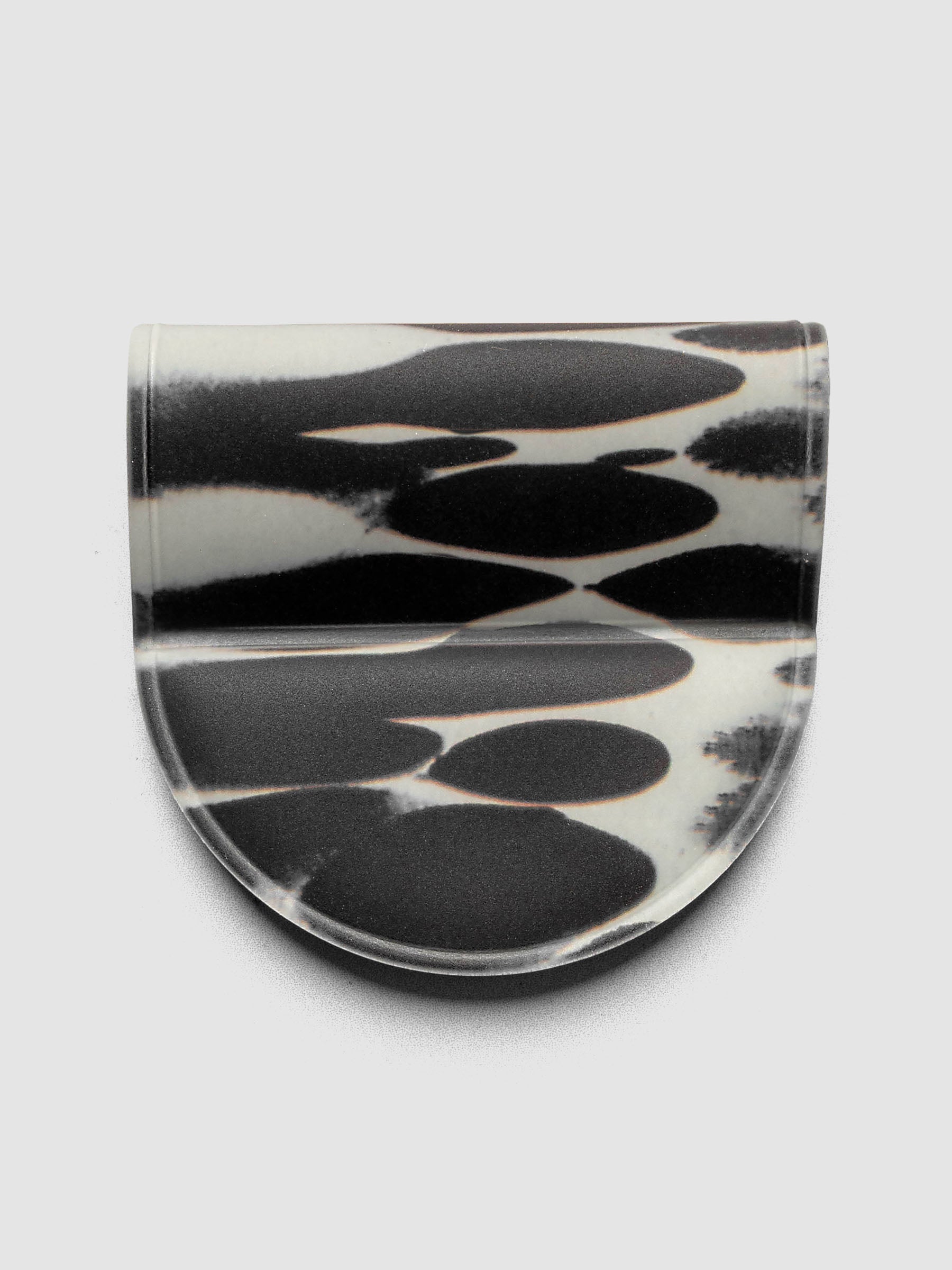 Magnetic Bookmark | Pen Holder | Vinyl in Dissolve, front view showing high-contrast black and off-white oval pattern