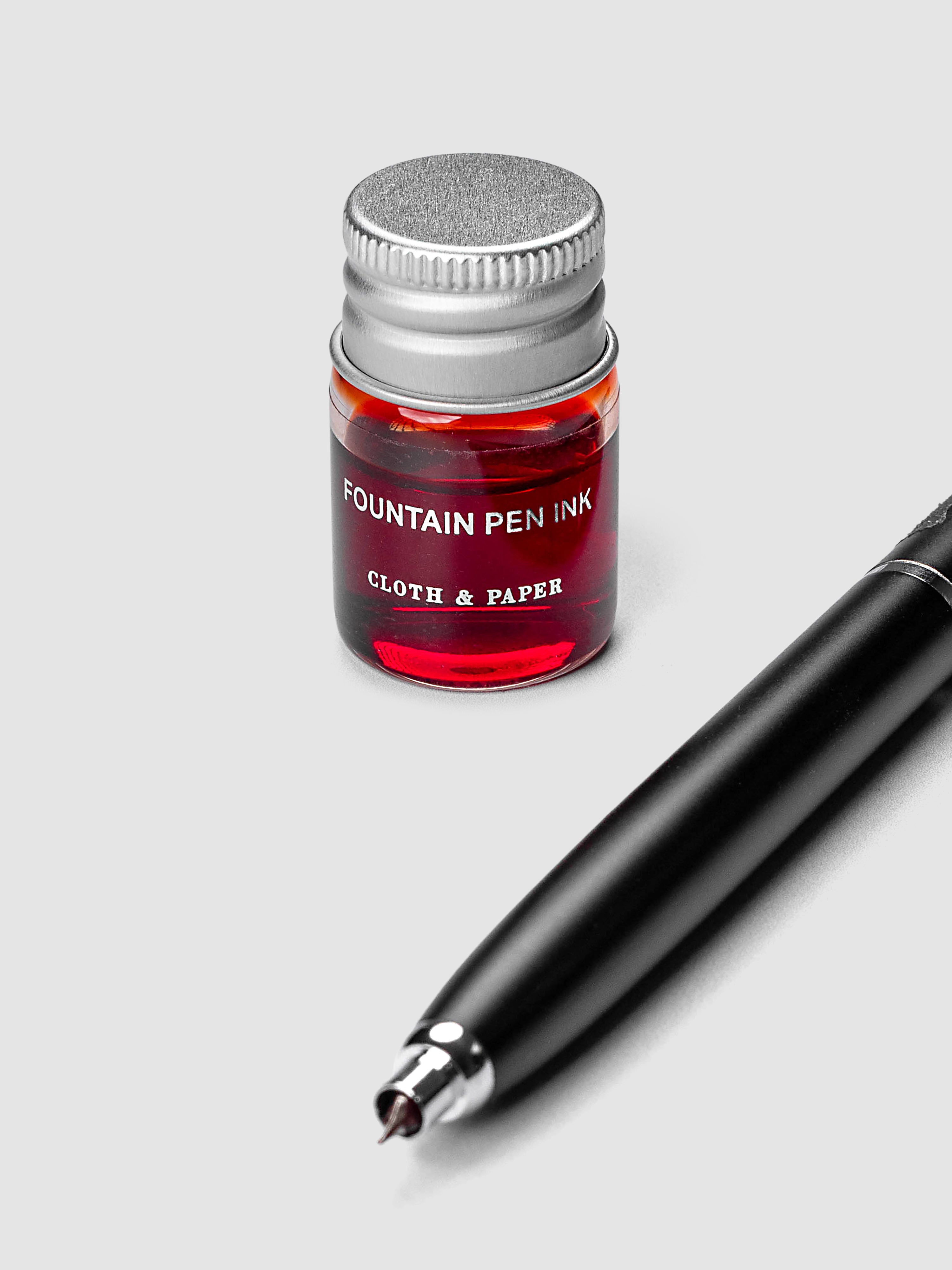 Mini Fountain Pen Ink in Saffron, 5 mL clear glass bottle beside a Lanbitou fountain pen
