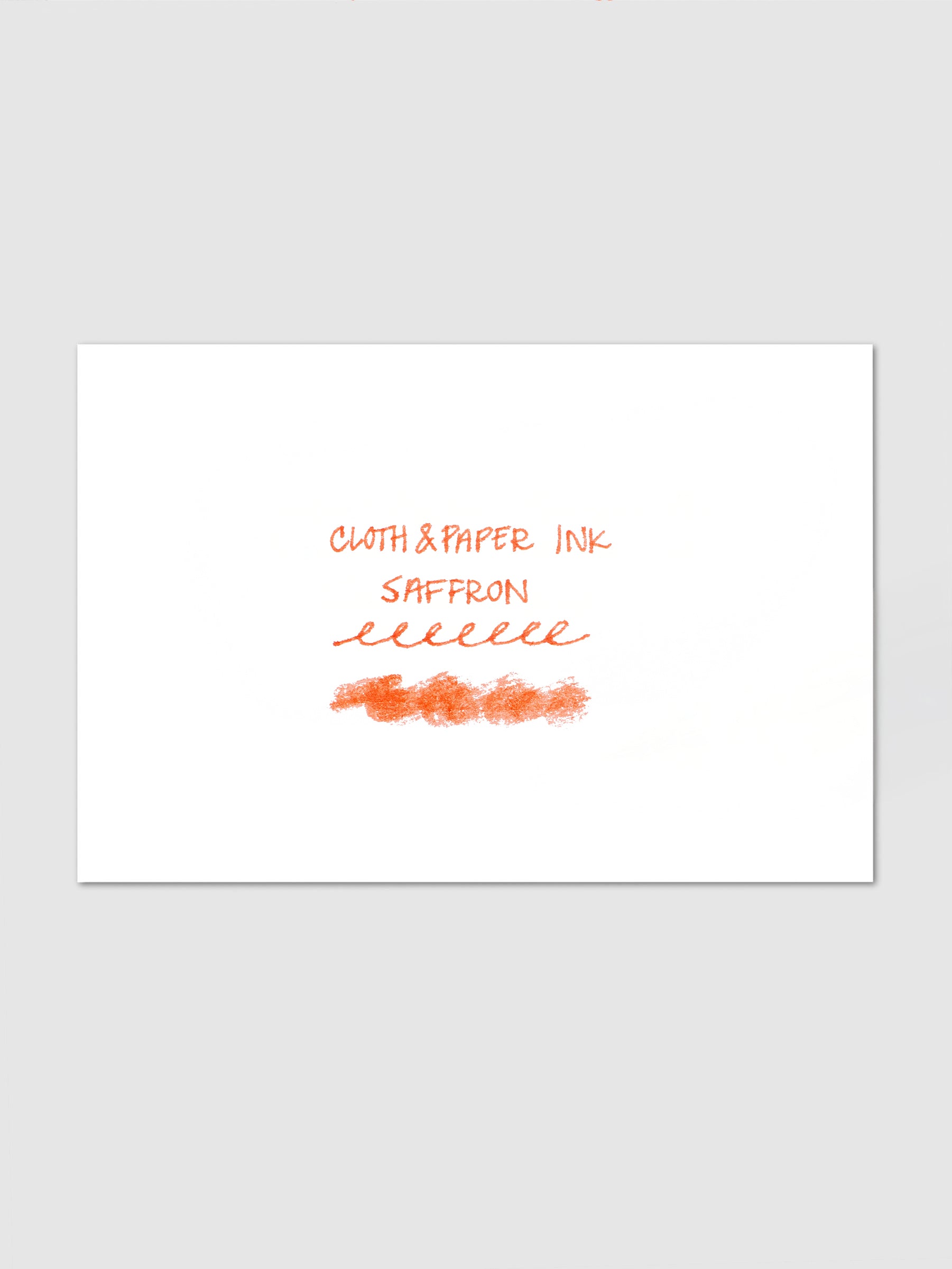 Mini Fountain Pen Ink in Saffron, handwriting sample in warm orange ink on white paper