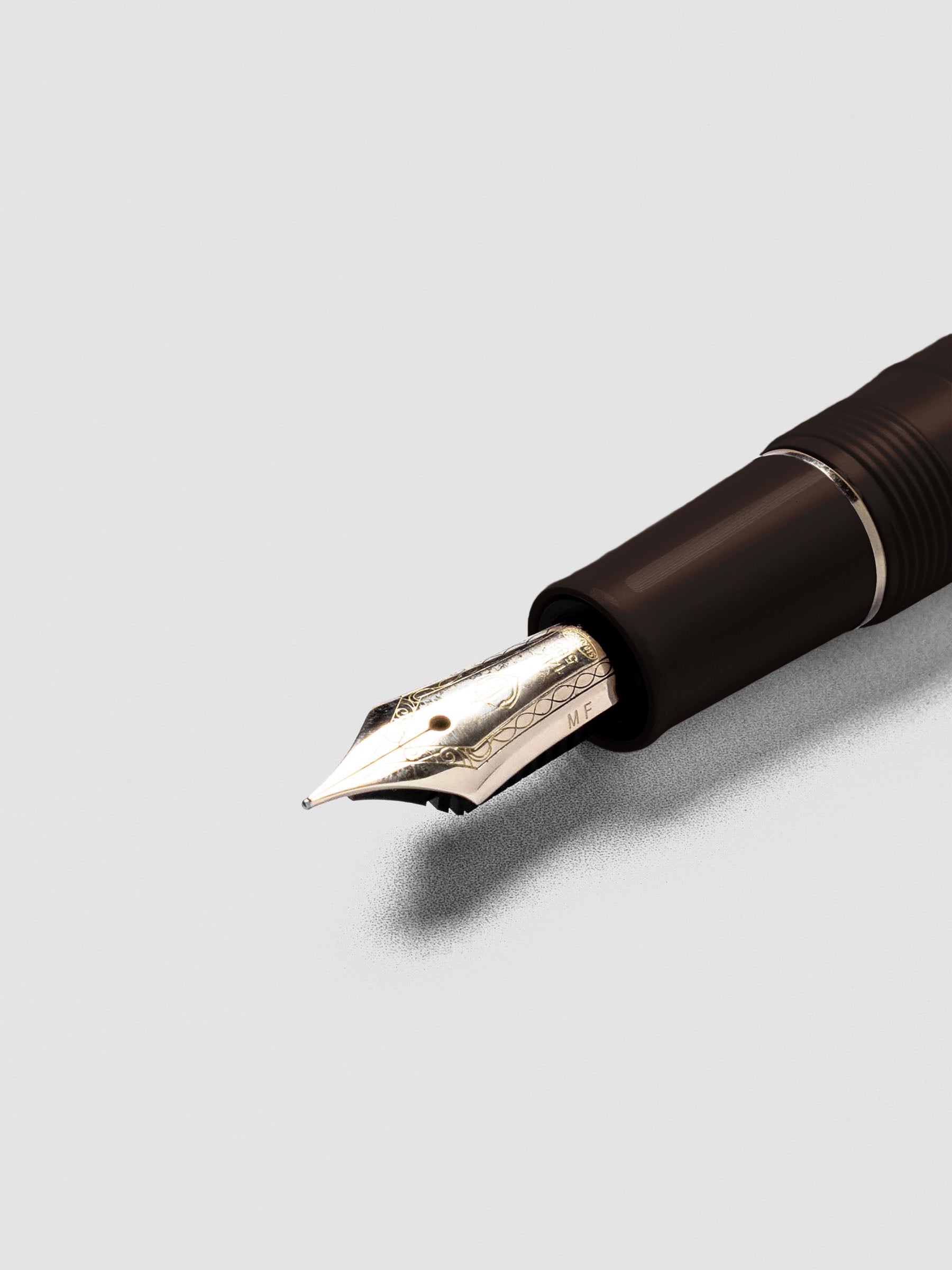 Uncapped Sailor Pro Gear Slim Mini Fountain Pen in Puff Brown with nib visible.