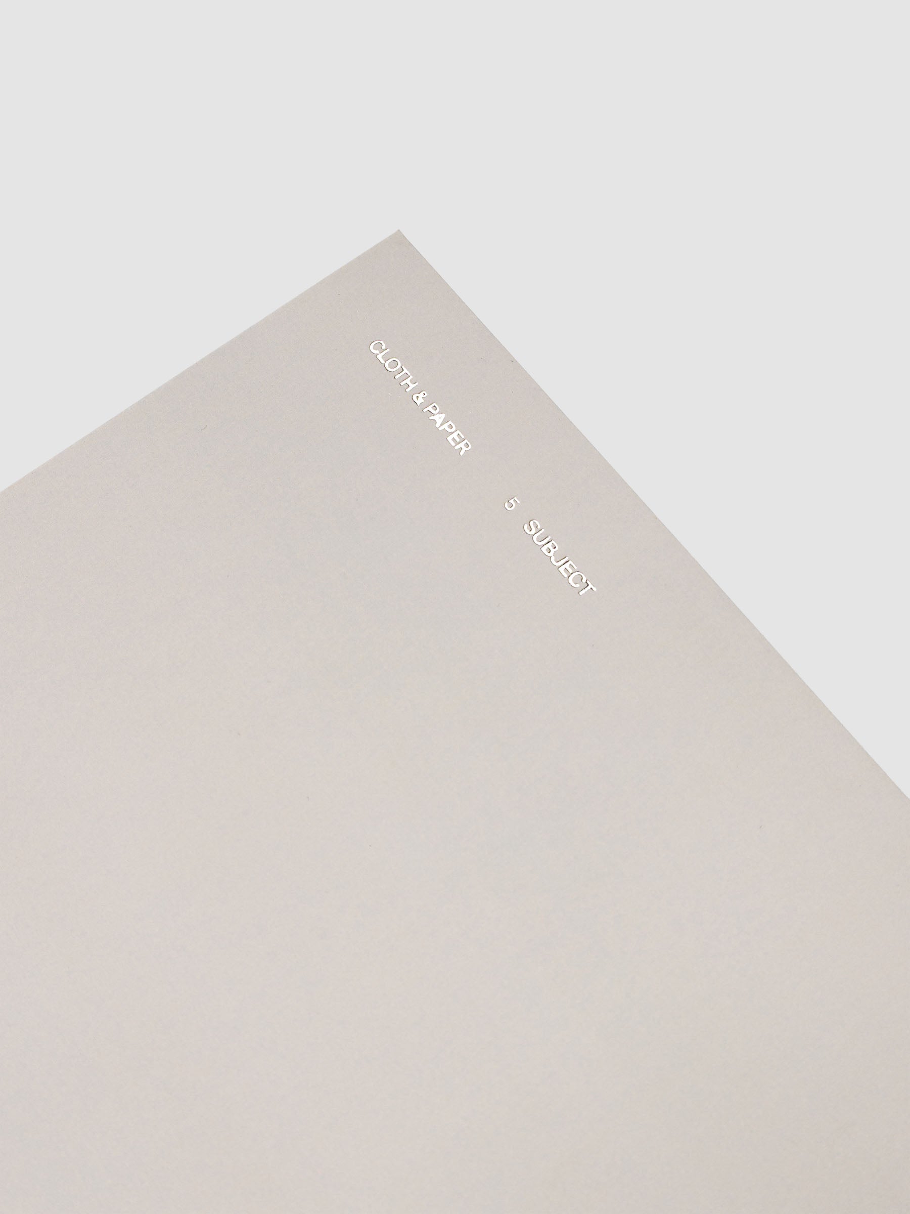 5 Subject Notebook A5 Punch top corner close up of light grey cover with silver foil branding