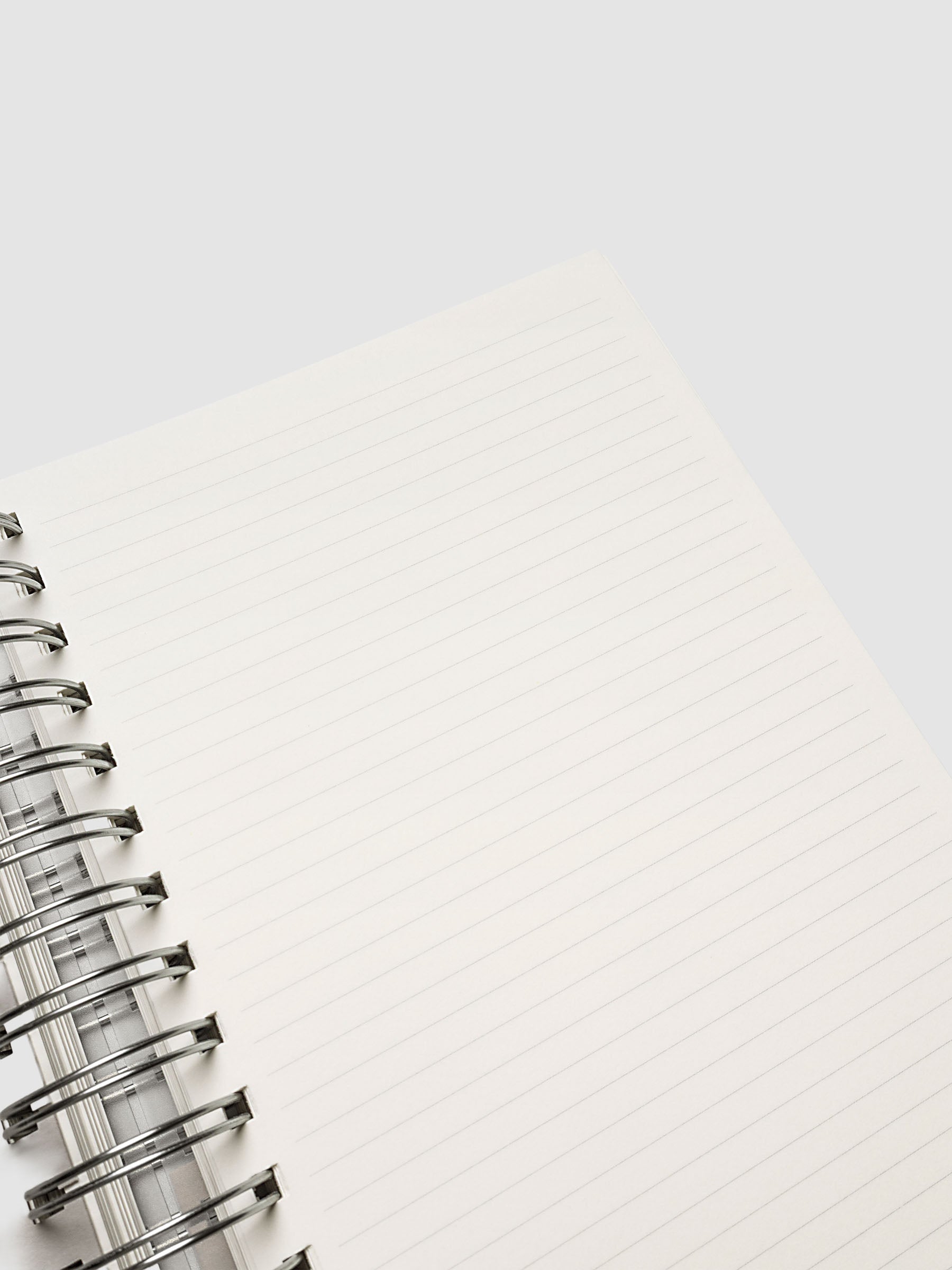 5 Subject Notebook A5 Punch close up of cream lined page corner with silver spiral binding