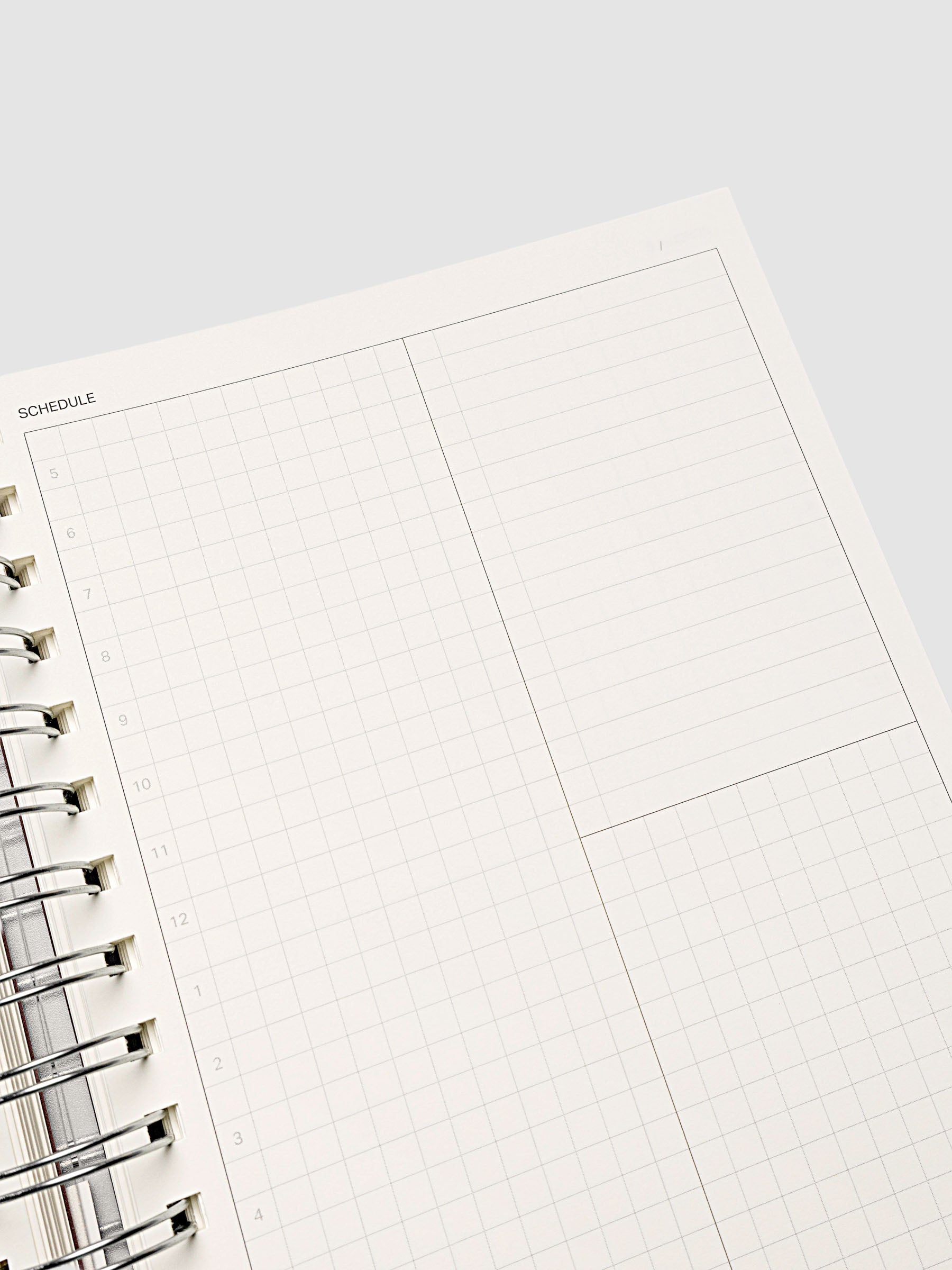 Spiral Notebook in size A5 and color Espresso brown with Daily Time Block interior pages shown open and close up.