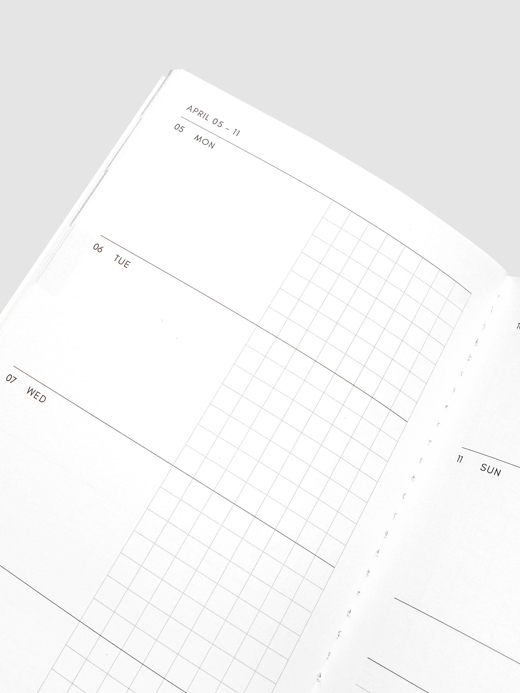 Close-up of the top of the left page of the Jan–Jun 2027 Dated Travel Notebook, showing the split daily columns with open space and graph sections