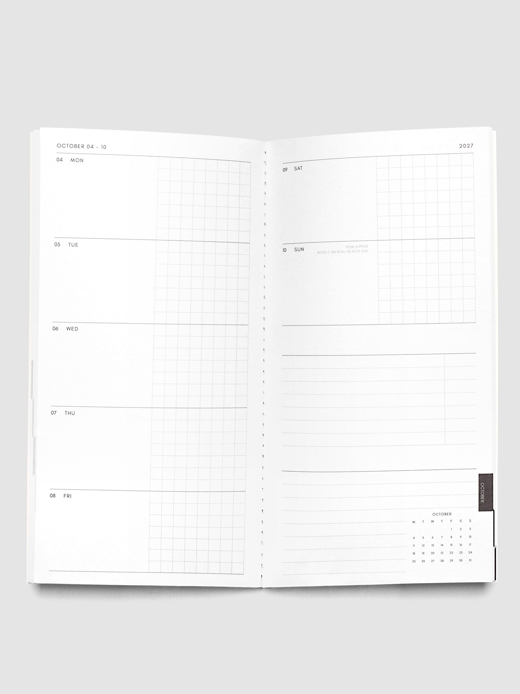 Open Jul–Dec 2027 Dated Travel Notebook showing the full weekly spread, with split daily columns on the left page and weekend dates, task section, notes section, and month-at-a-glance on the right