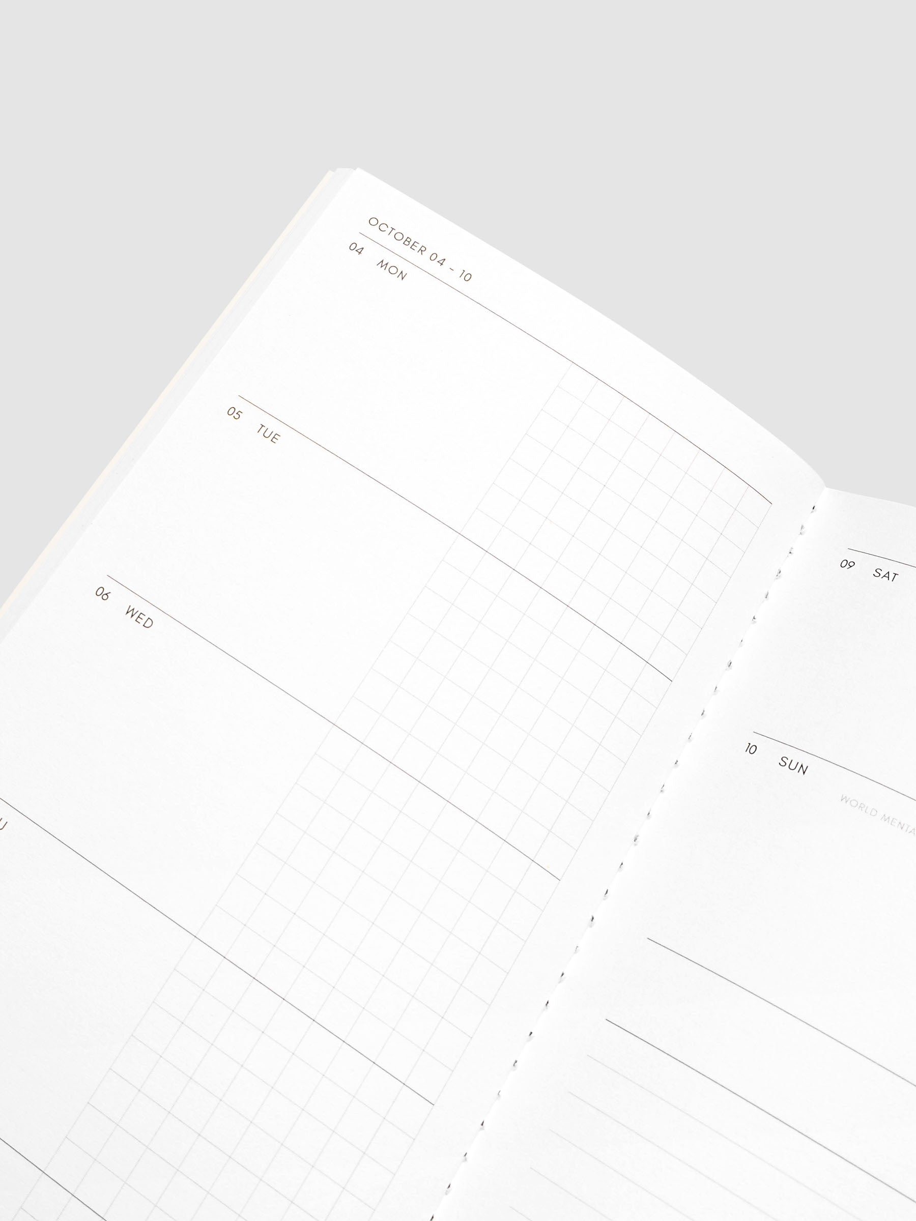 Close-up of the top of the left page of the Jul–Dec 2027 Dated Travel Notebook, showing the split daily columns with open space and graph sections