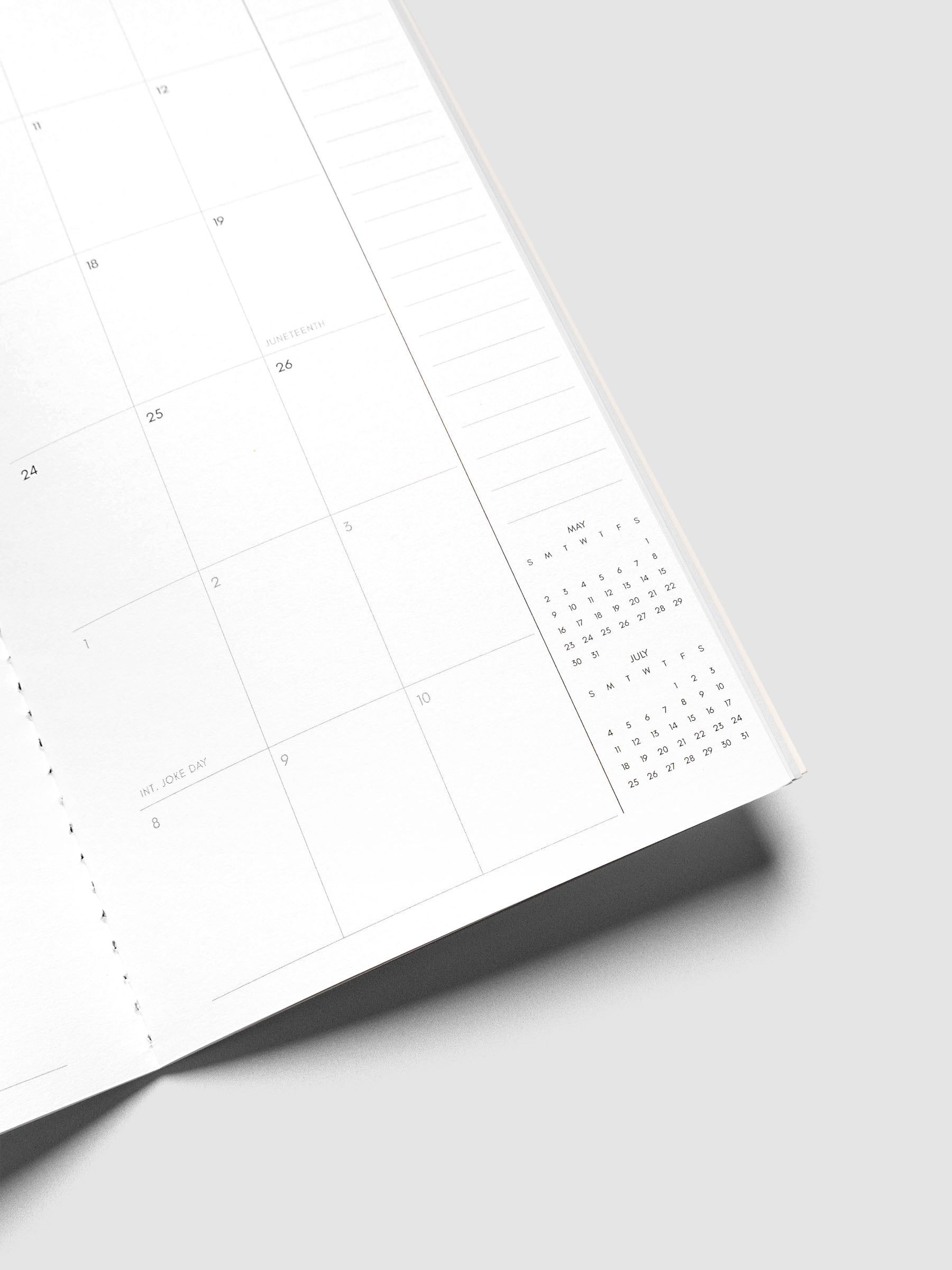 Close-up of the bottom of the right page of the 2027 Dated Travel Notebook Monthly in A5 Slim size, showing the lower dated calendar grid, notes section, and mini calendars for the prior and following month