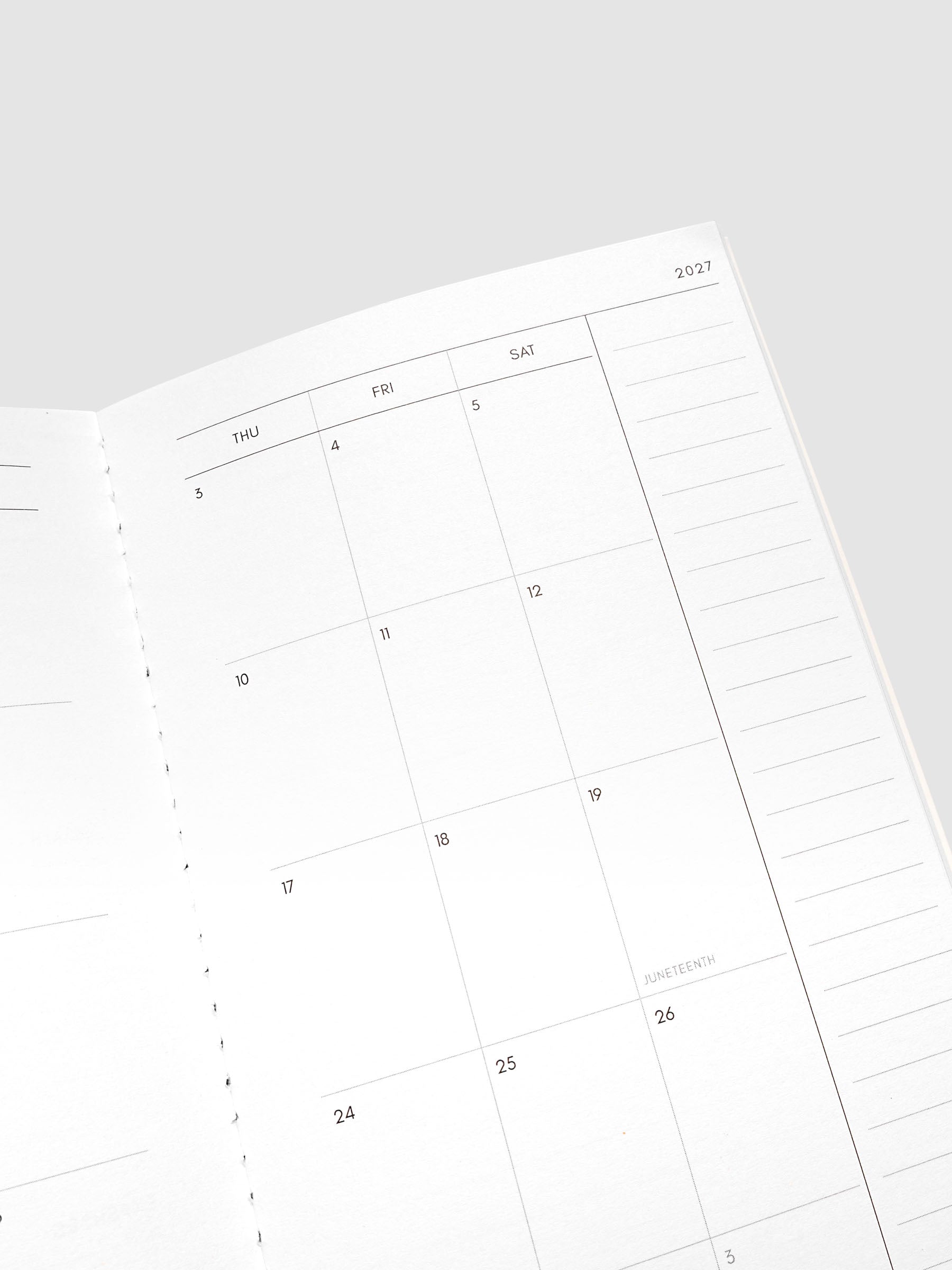 Close-up of the top of the right page of the 2027 Dated Travel Notebook Monthly in A5 Slim size, showing the dated calendar grid and notes section