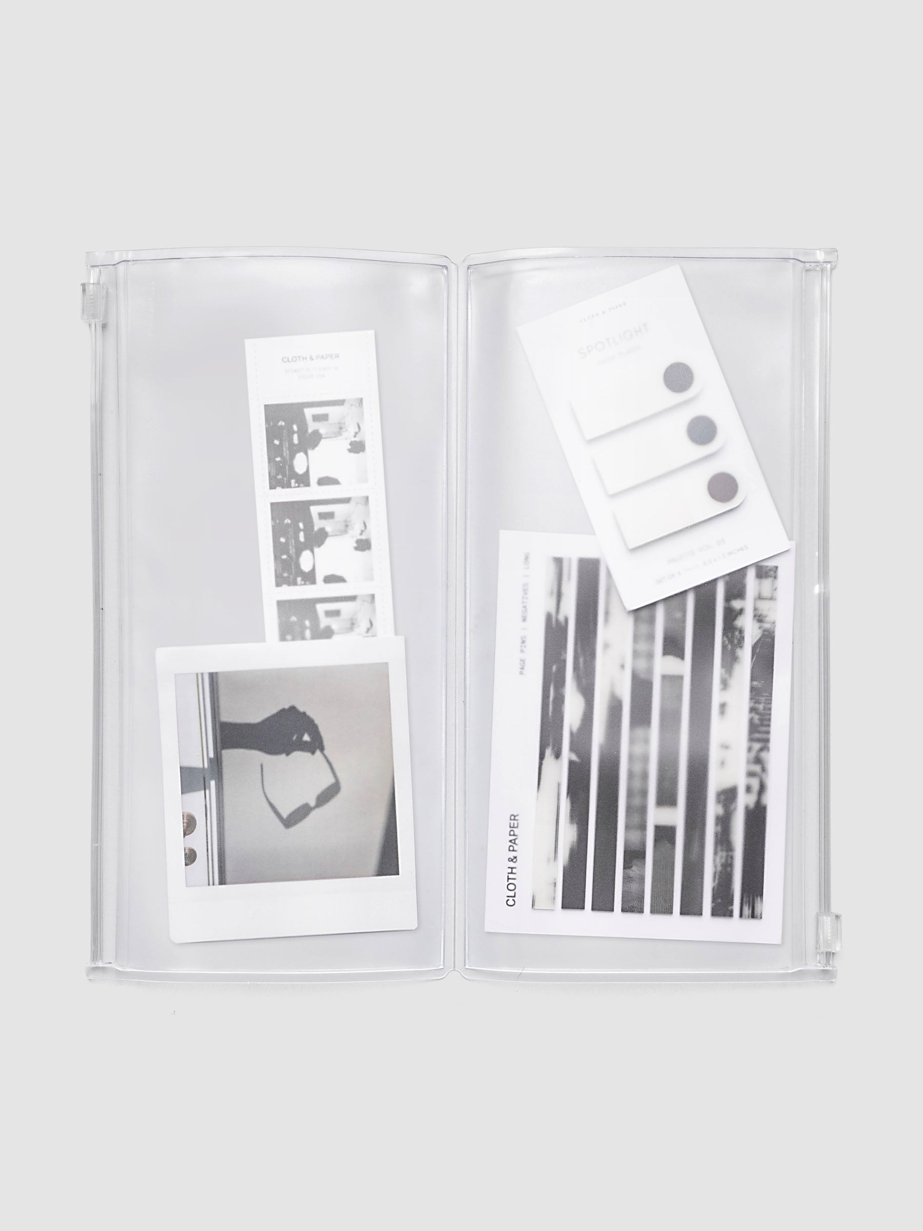 Storage Holder Travel Notebook A5 Slim open with stickers, page pins, and a journaling card organized across two zippered pouches