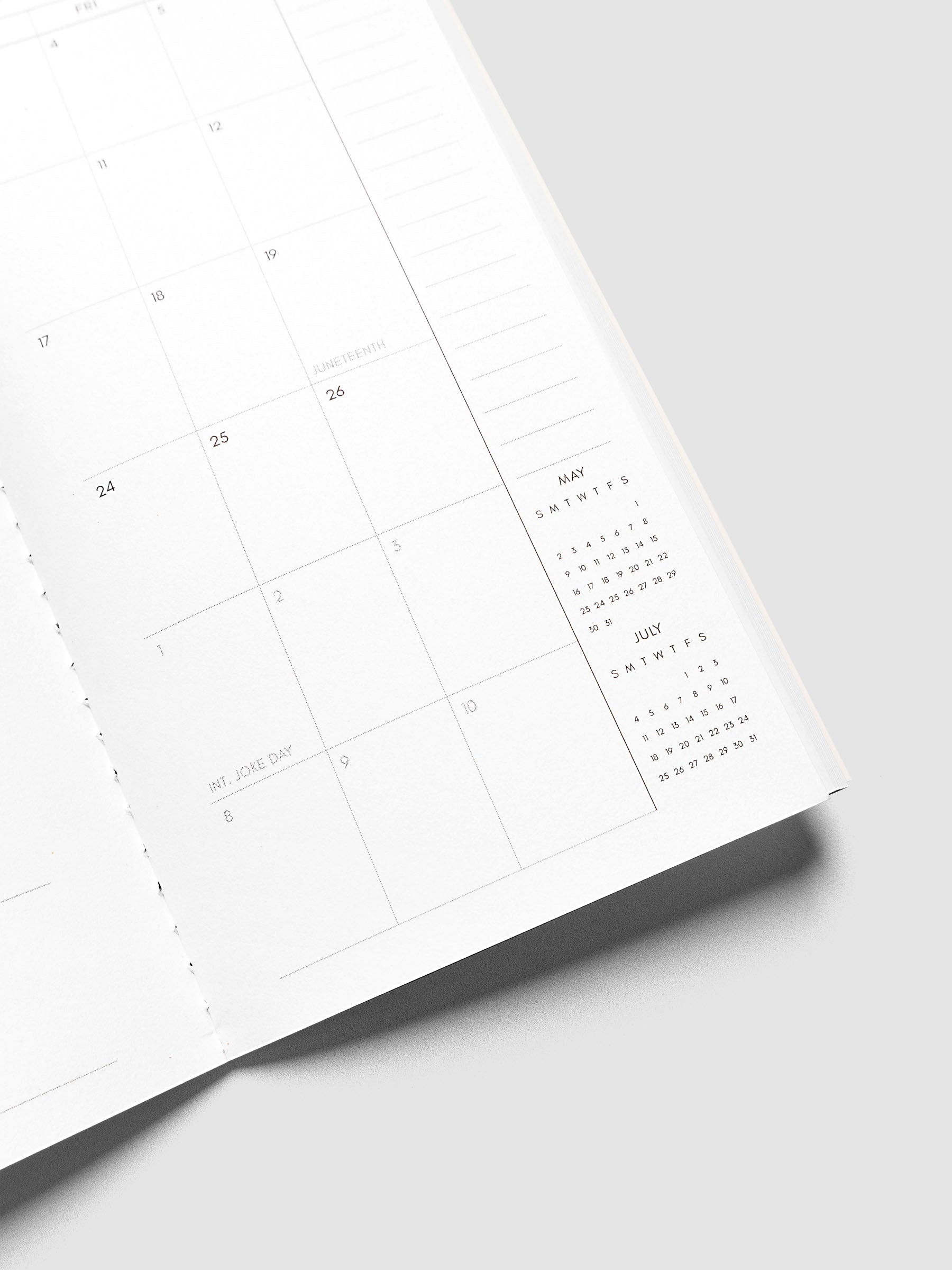 Close-up of the bottom of the right page of the 2027 Dated Travel Notebook Monthly in Pocket Plus size, showing the lower dated calendar grid, notes section, and mini calendars for the prior and following month