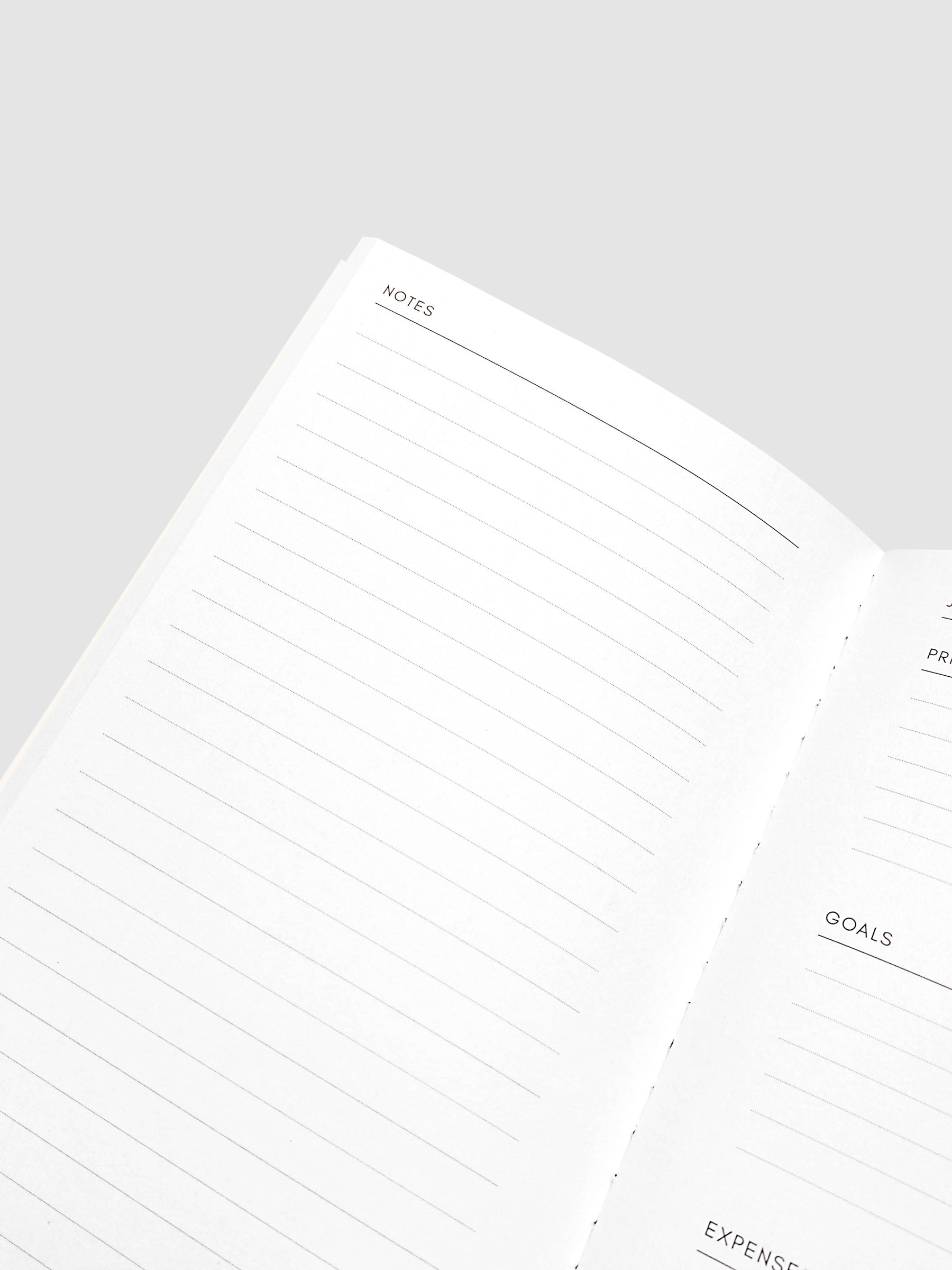Close-up of the top of the left page of the 2027 Dated Travel Notebook Monthly in Pocket Plus size, showing the lined notes section