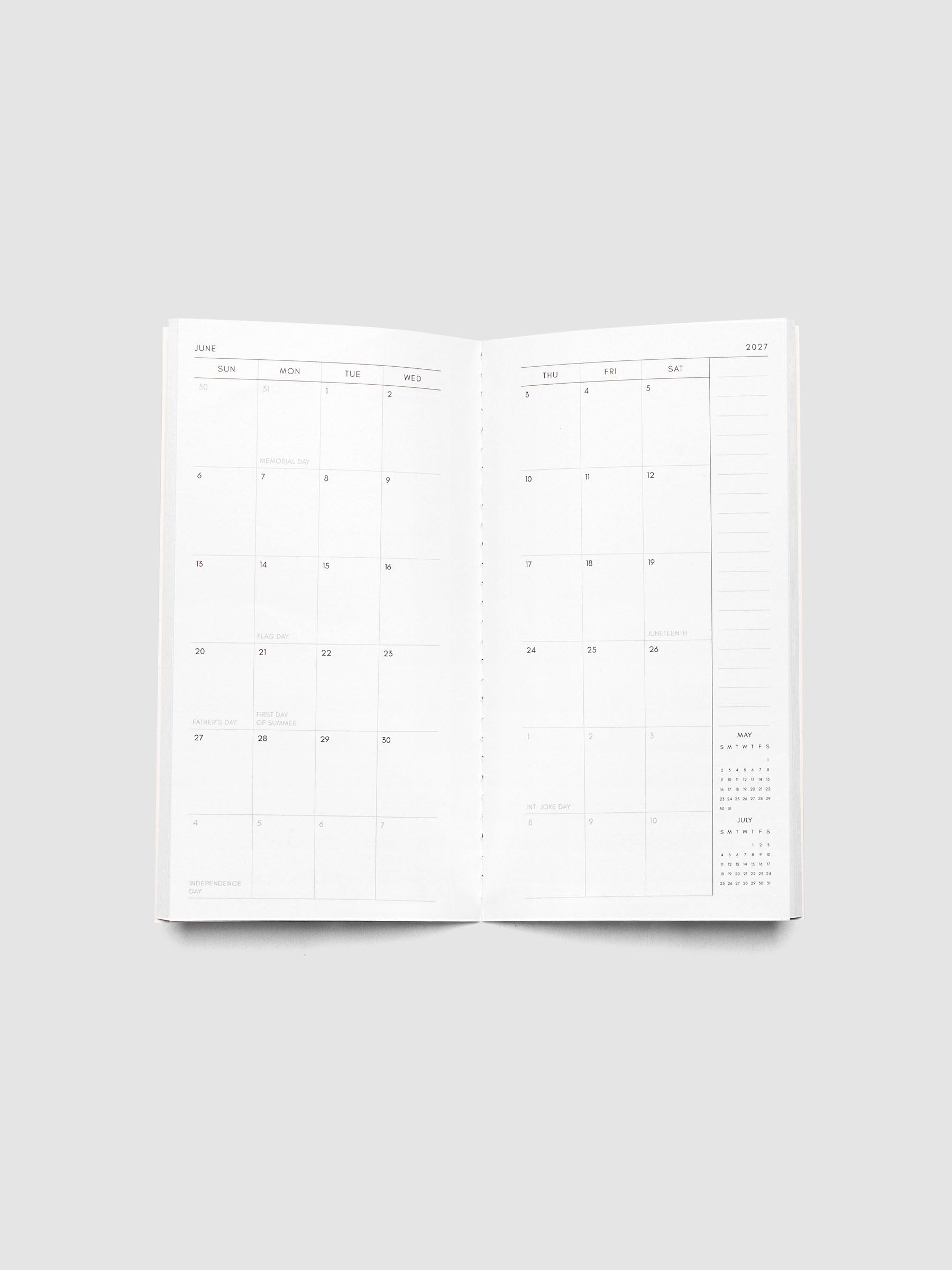 Open 2027 Dated Travel Notebook Monthly in Pocket Plus size showing the full two-page dated calendar spread