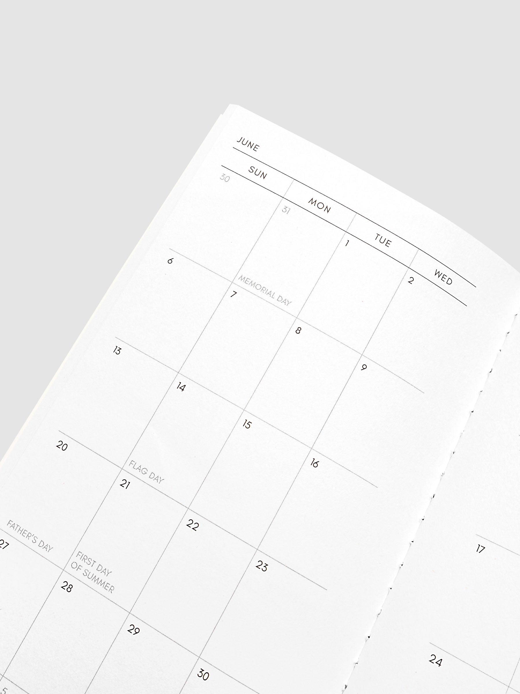 Close-up of the top of the left page of the 2027 Dated Travel Notebook Monthly in Pocket Plus size, showing the dated calendar grid