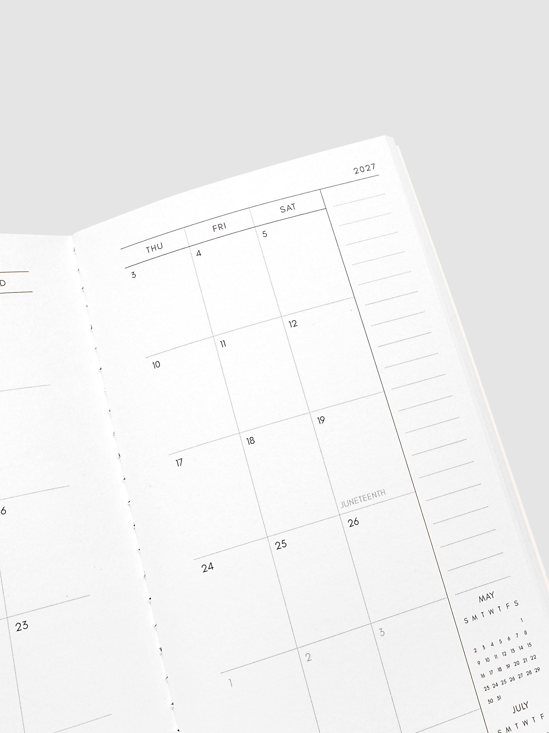 Close-up of the top of the right page of the 2027 Dated Travel Notebook Monthly in Pocket Plus size, showing the dated calendar grid and notes section