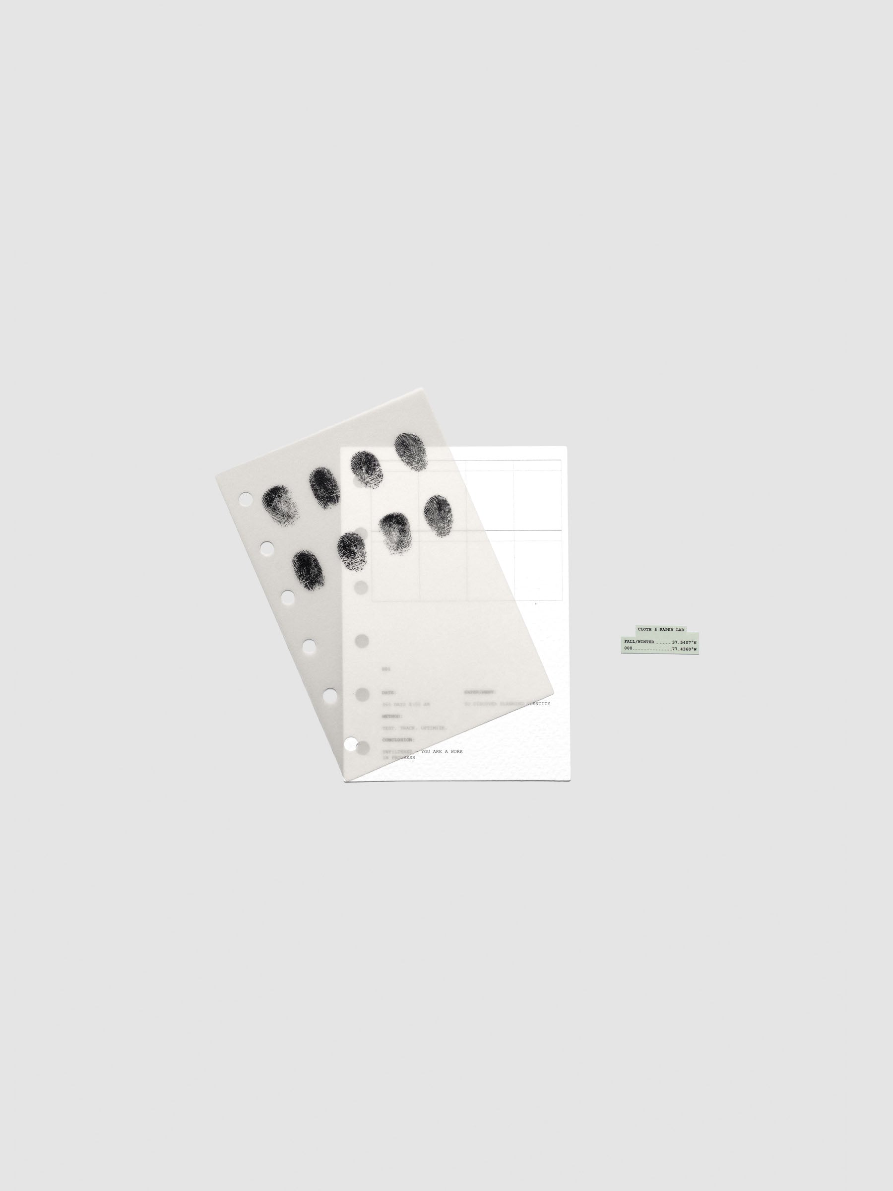 Two layered Pocket sized planner dashboards, one semi-transparent, one matte, featuring a fingerprint design shown offset from one another.