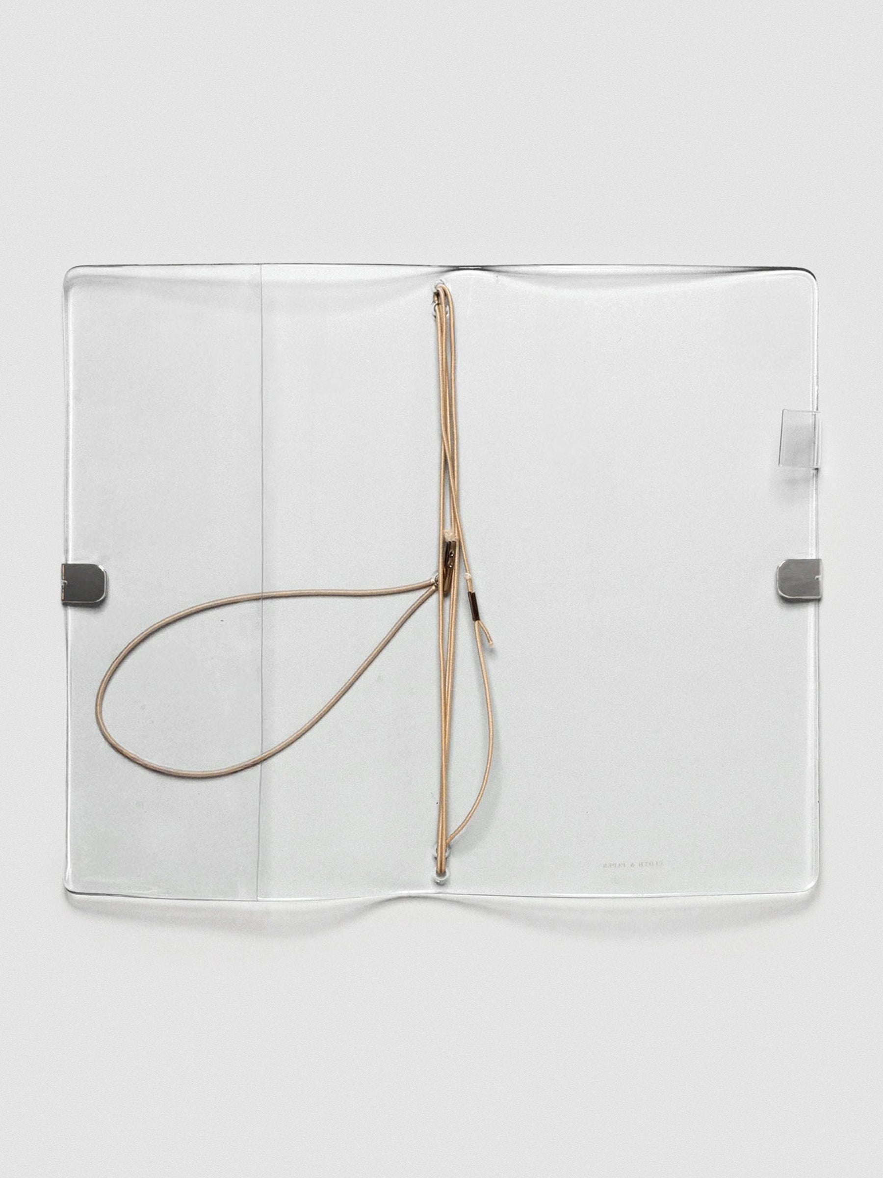 A clear vinyl planner on a neutral background