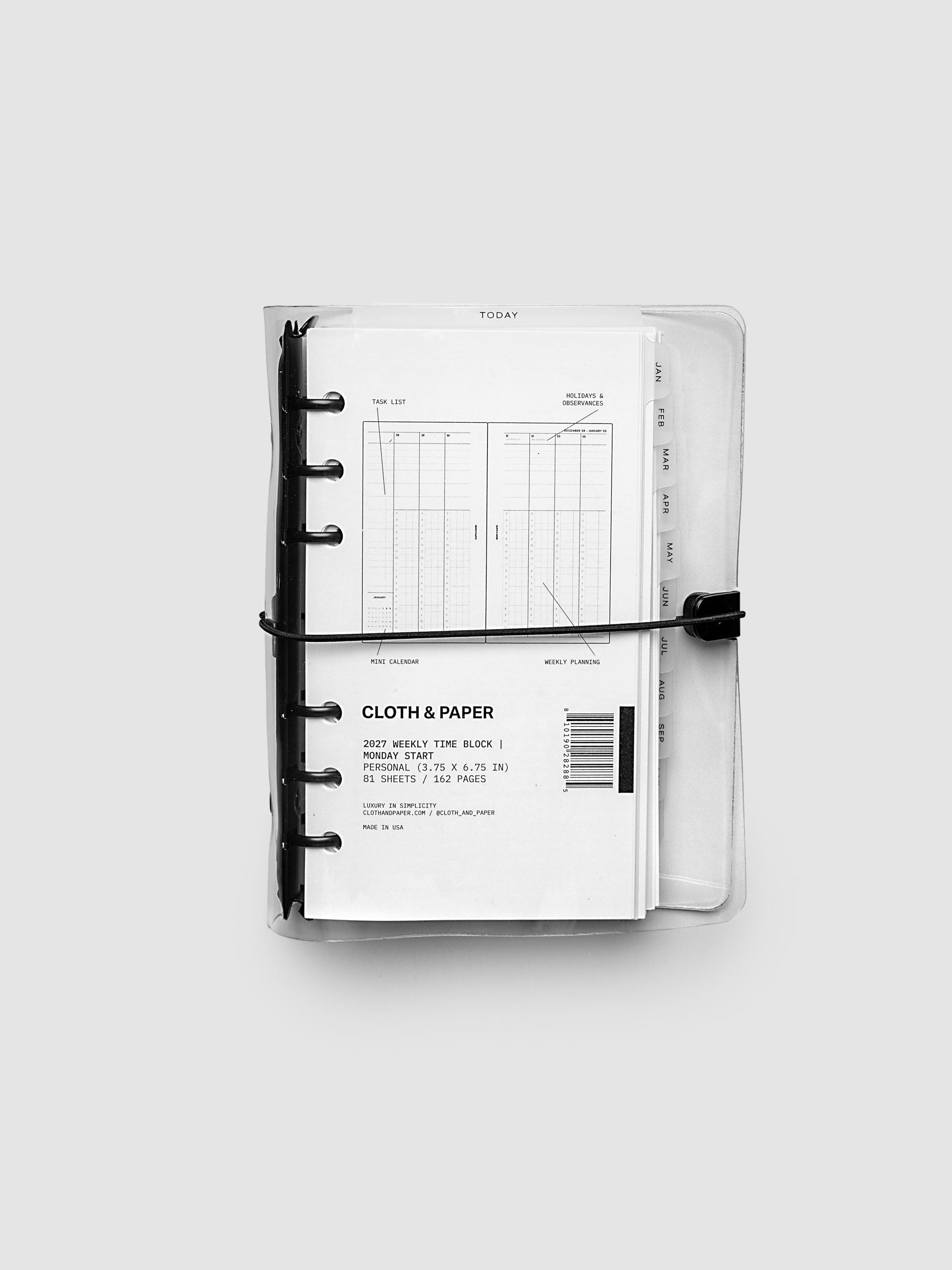 Closed clear vinyl planner cover with black 6-ring binding and a black elastic closure, front page displaying a labeled weekly time block spread with task list, holidays and observances, mini calendar, and weekly planning callouts, Personal 6-Ring Punch size
