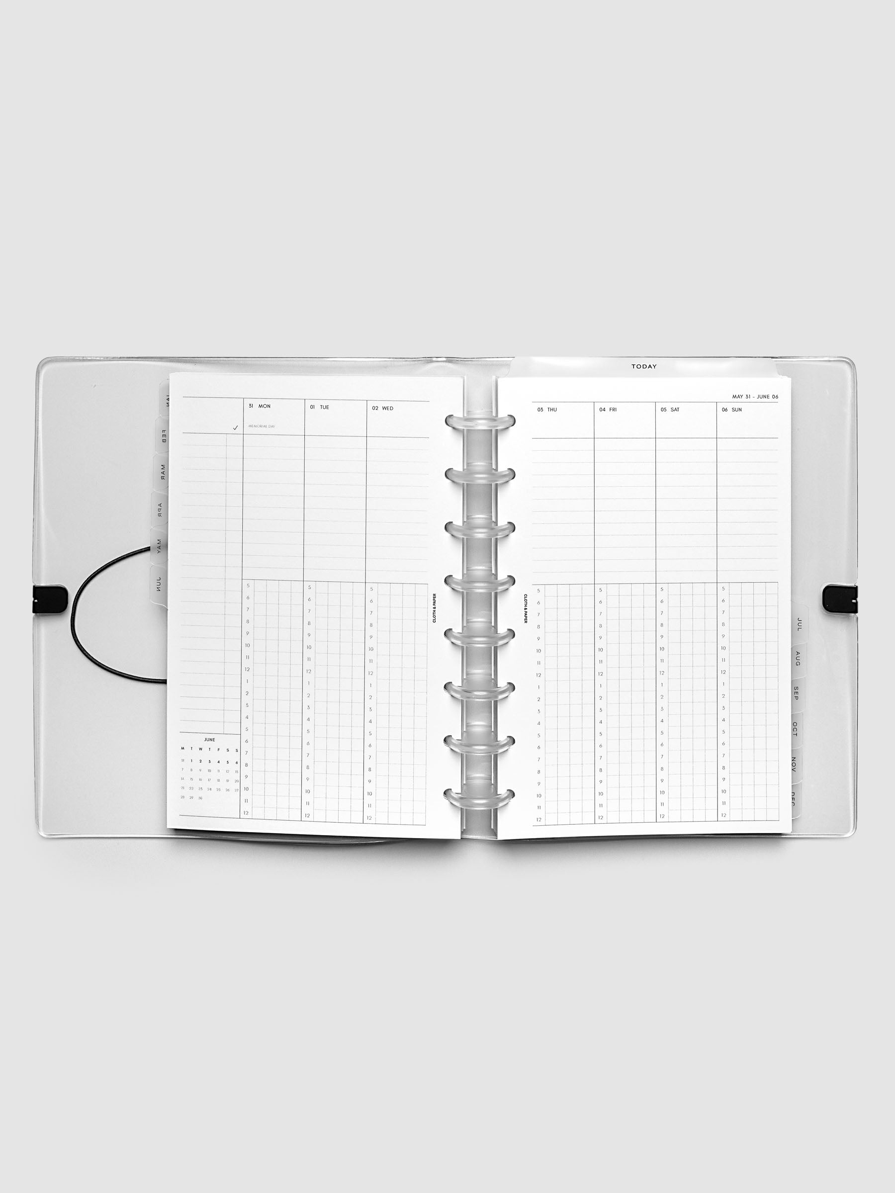 Flat lay of an open planner with clear 8-disc binding at the center, a Monday through Sunday weekly time block spread across two facing pages with task lists, hourly grids, and a mini monthly calendar, Half Letter 8-Disc Punch size