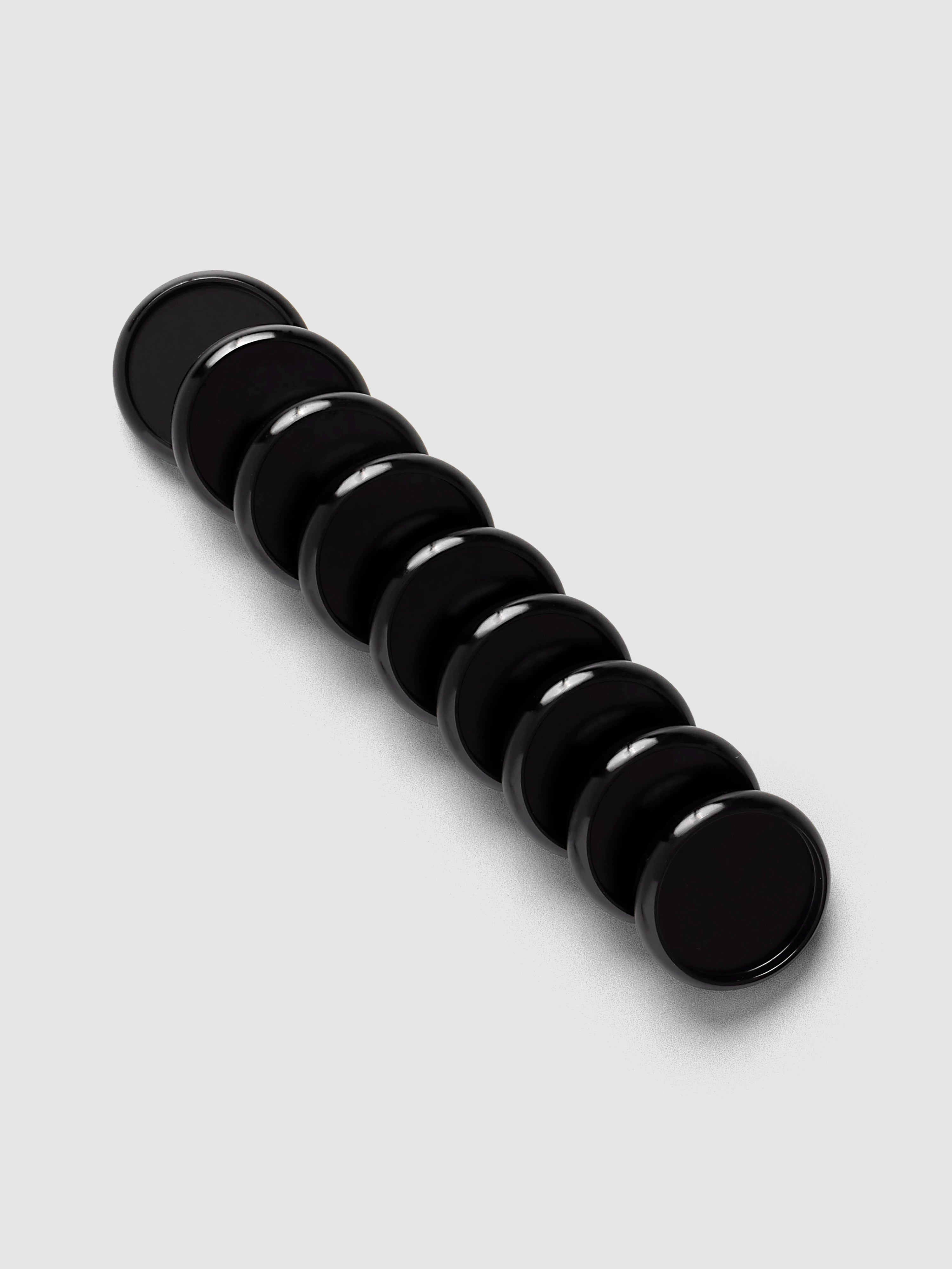 Aluminum Planner Discs | Black, 1 Inch, set of nine arranged in a diagonal line on a neutral background
