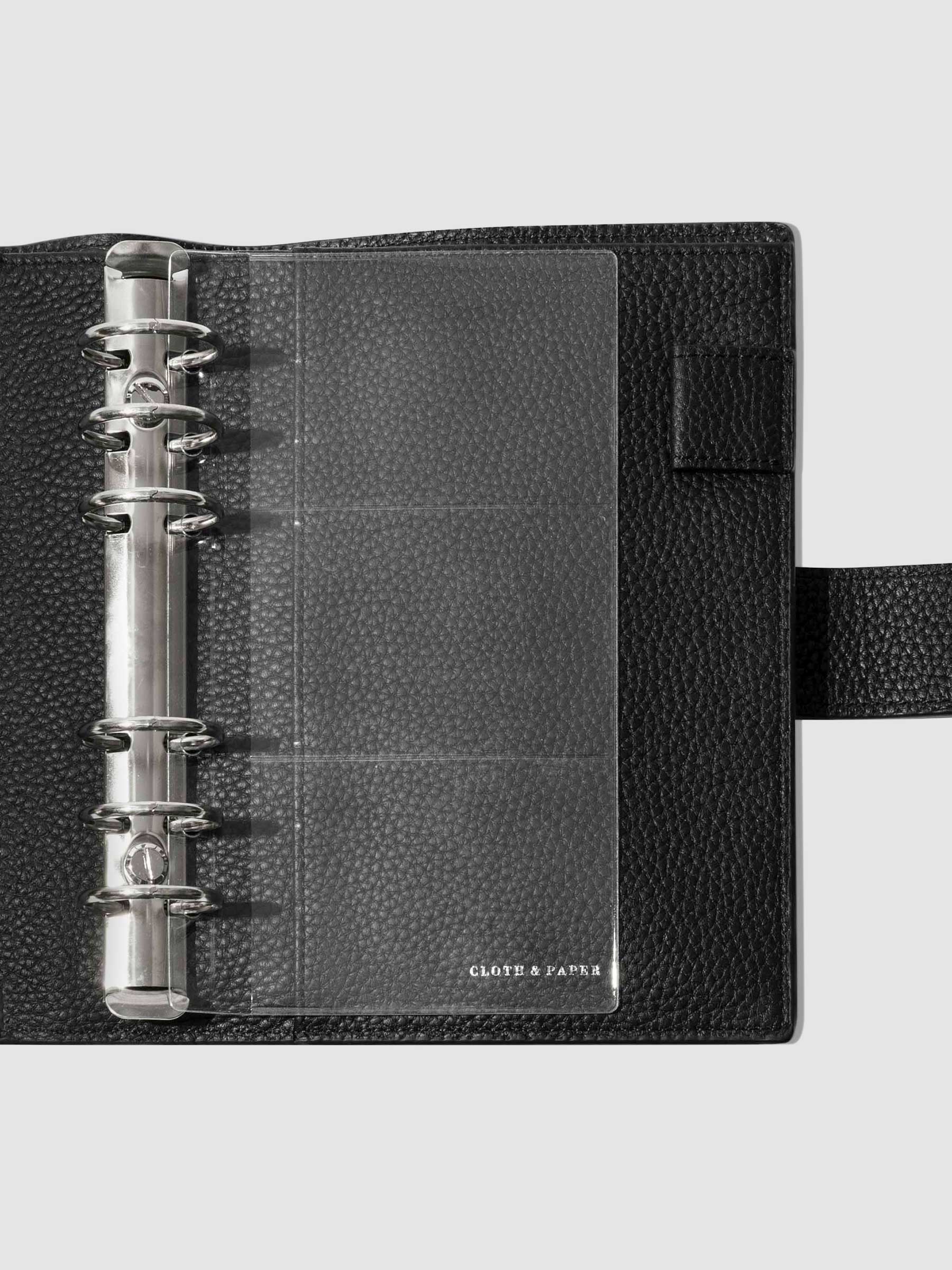 Credit card holders in use inside a black leather folio. Size shown is Personal. 