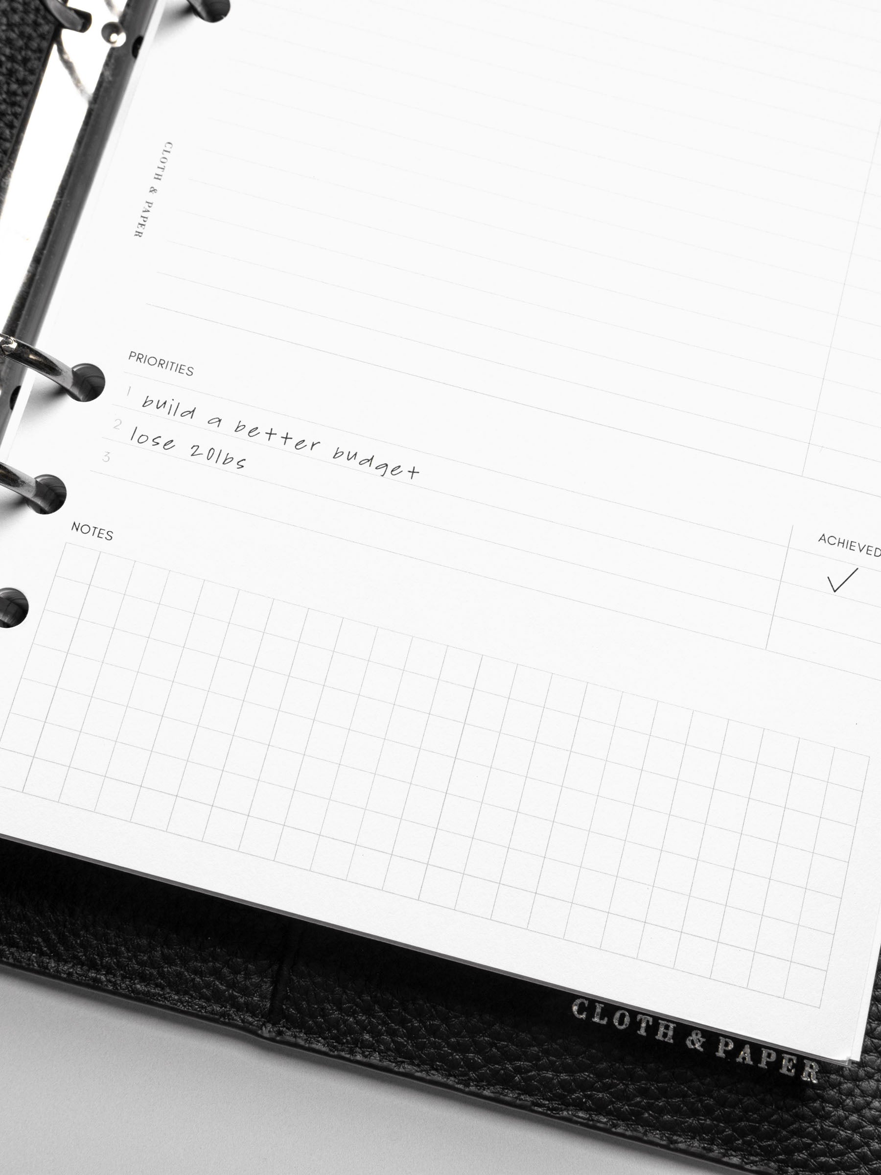 Close up of Goal Mapping inserts inside discbound planner and leather cover. 