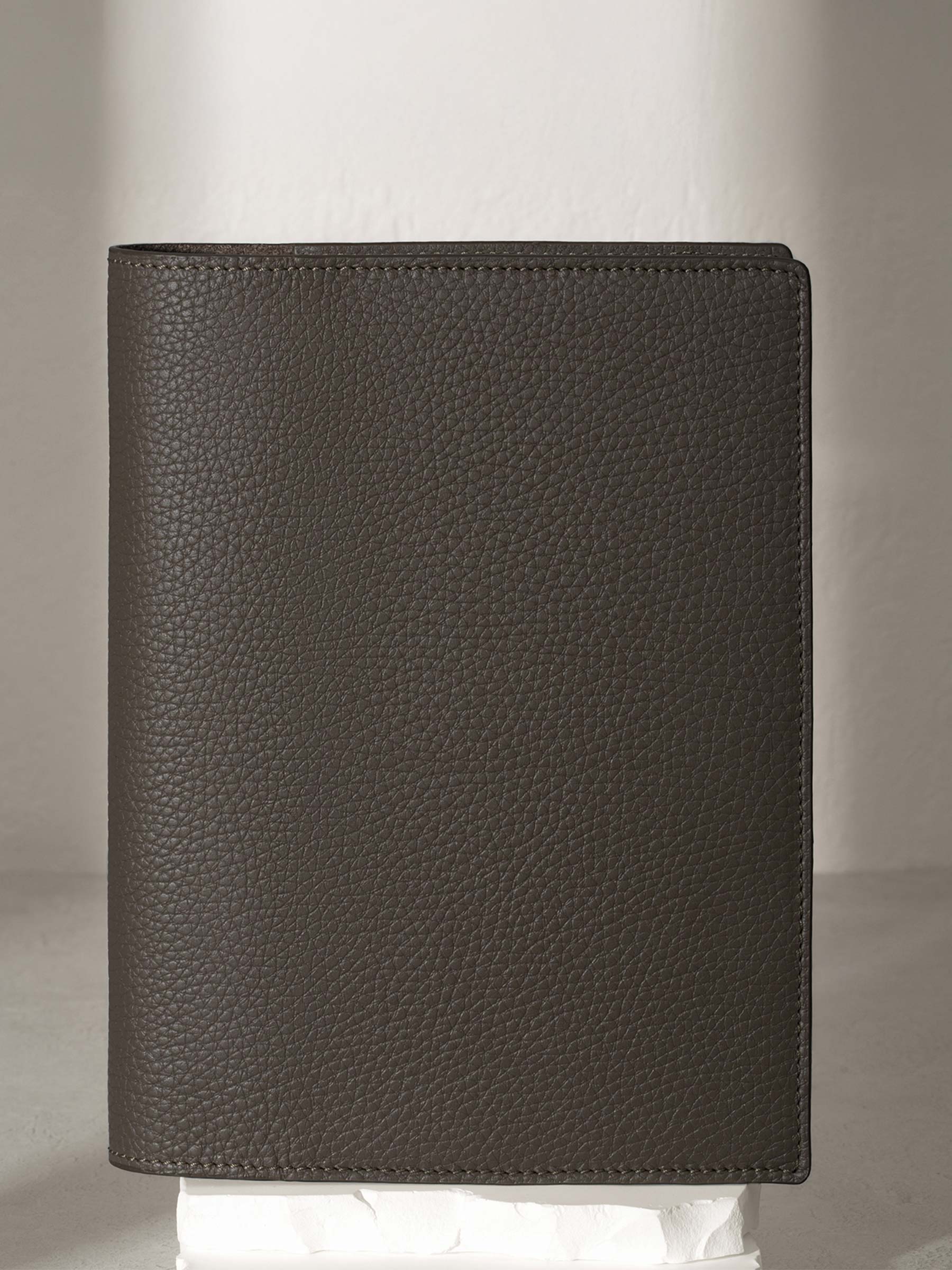 Leon  folio displayed on a white pedestal.
