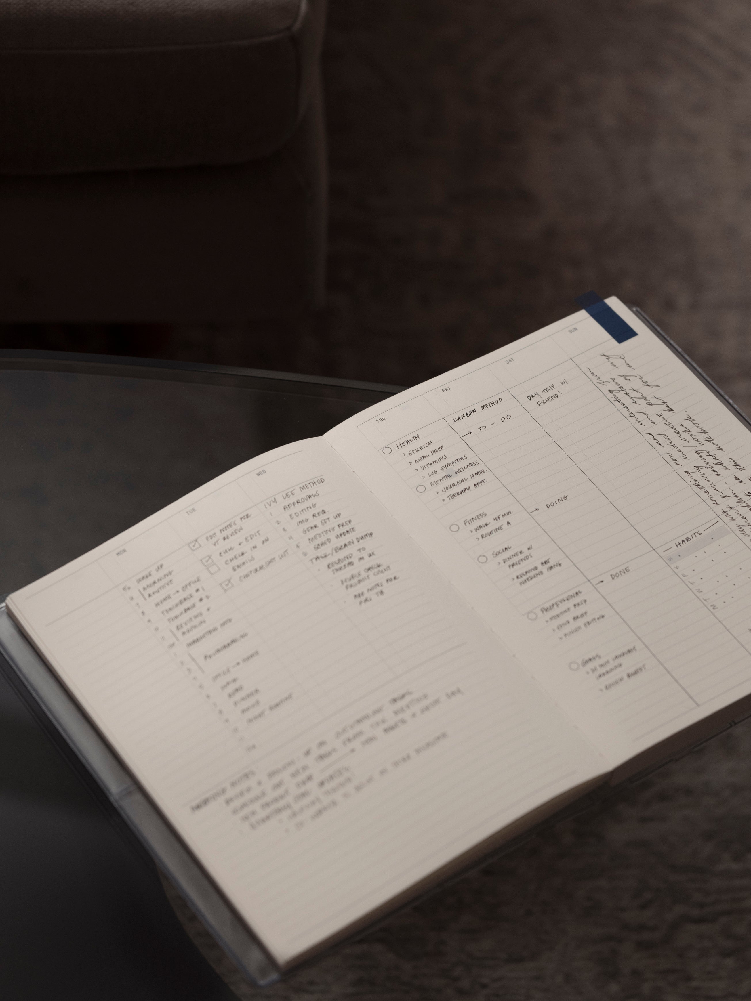 Analog Weekly Notebook in size HP Classic shown open with handwritten notes on a brown background.